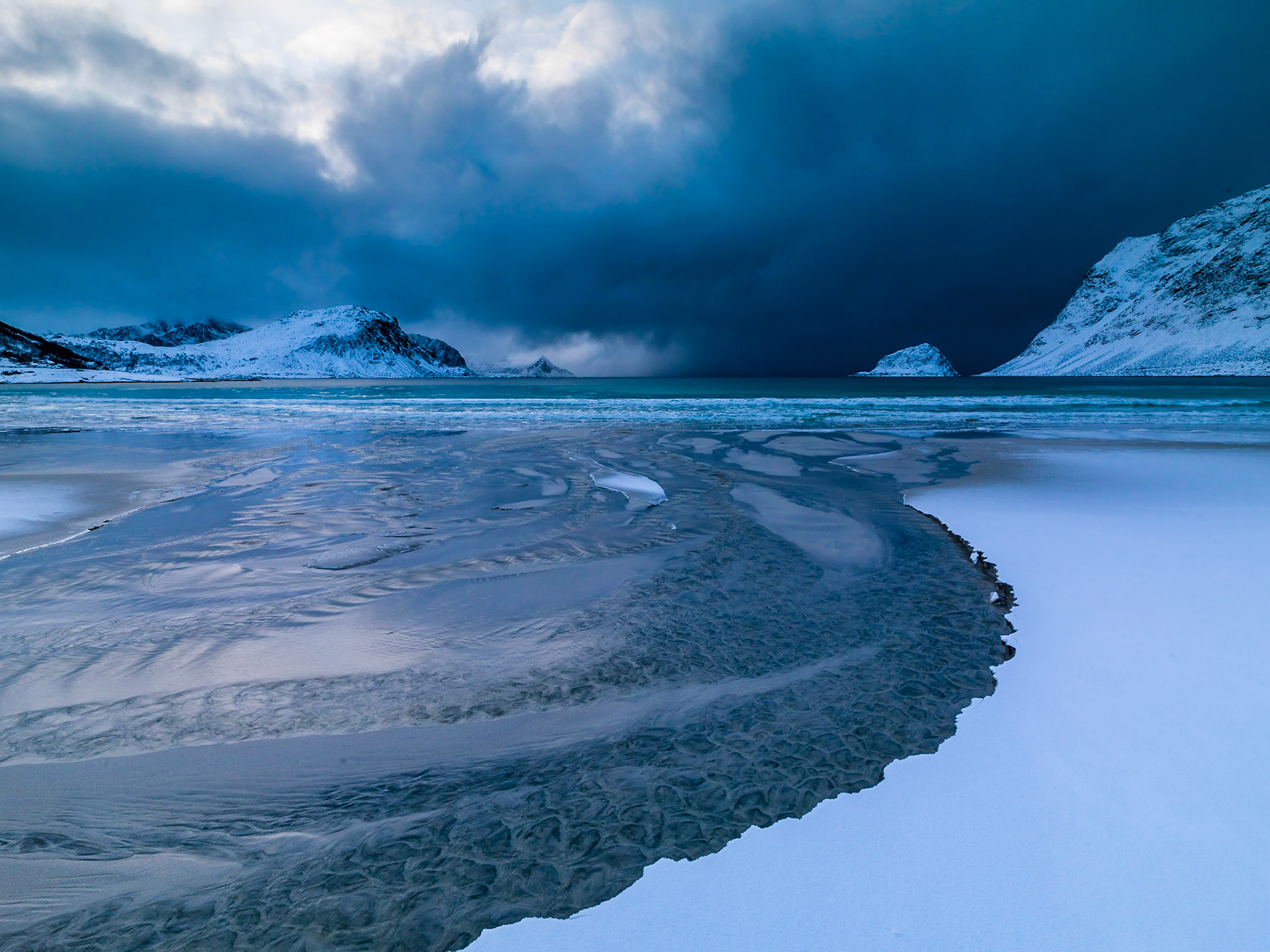 Snow storm coming in over Haukland Beach, Lofoten - Troms, Norway.