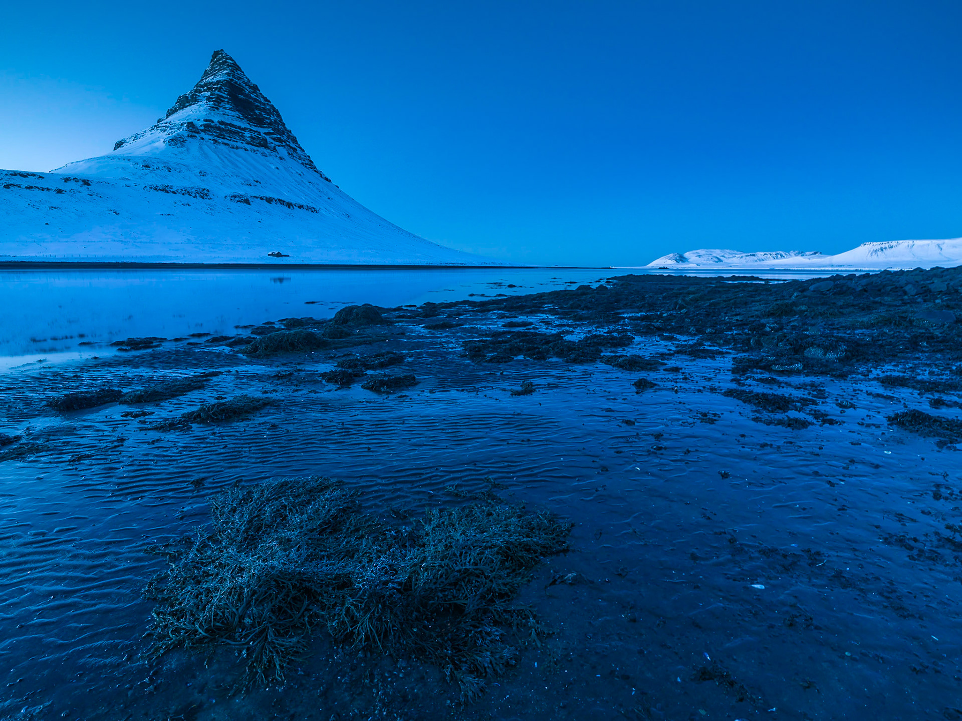 Capturing the beautiful Kirkjufell Mountain at the low tide during the Blue hour.