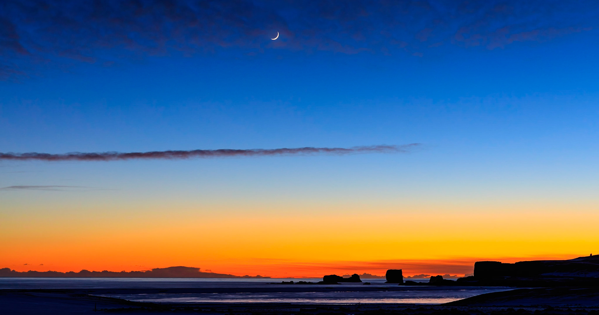 Moonrise and Sunset over Dyrholaey