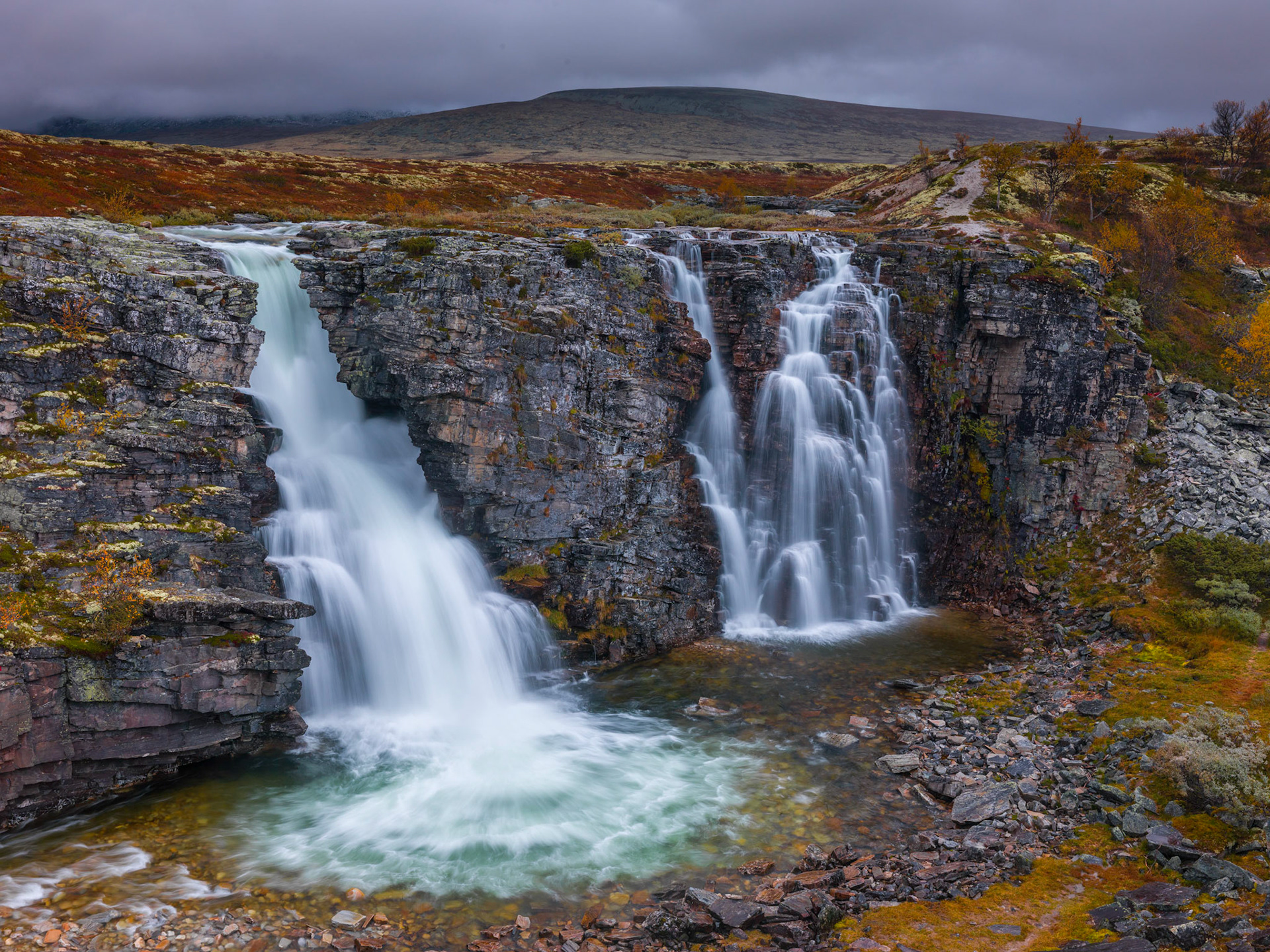 Autumn colors surrounds the Storulfossen in Rondane, Norway