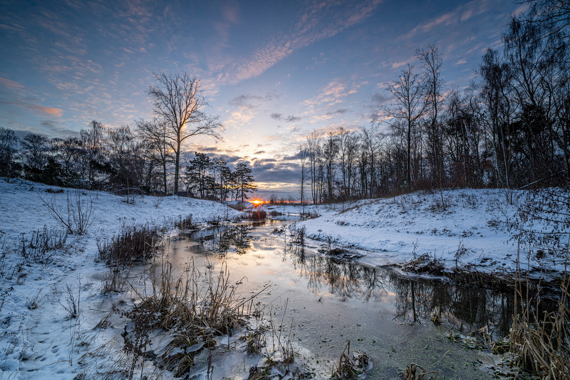 Living only 5 minutes away from this beautiful spot has the advantage that I can get up in the morning look out of the window facing east and determine if there is a fair chance of good clouds for the sunrise, so if all camera equipment is already packed it takes no time to get out and capture the beauty of nature painting in colors right before my eyes ... I never get tired of that and now with bonus of snow 🙂 Additional Exif: NiSi 15mm/F4 Lens (great for sunstars on all apertures).  NiSi V6 with Landscape CPL and 3 stop GND medium.