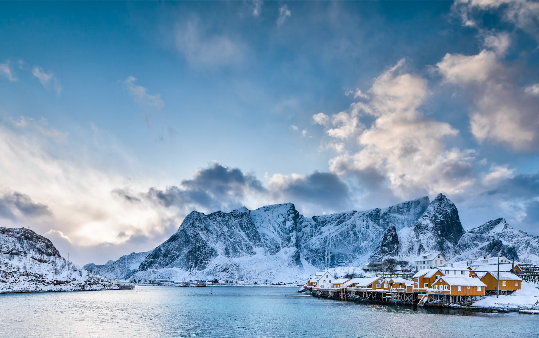 Beautiful Sakrioy Rorbuer Cabins as seen from the bridge on a nice winter afternoon.