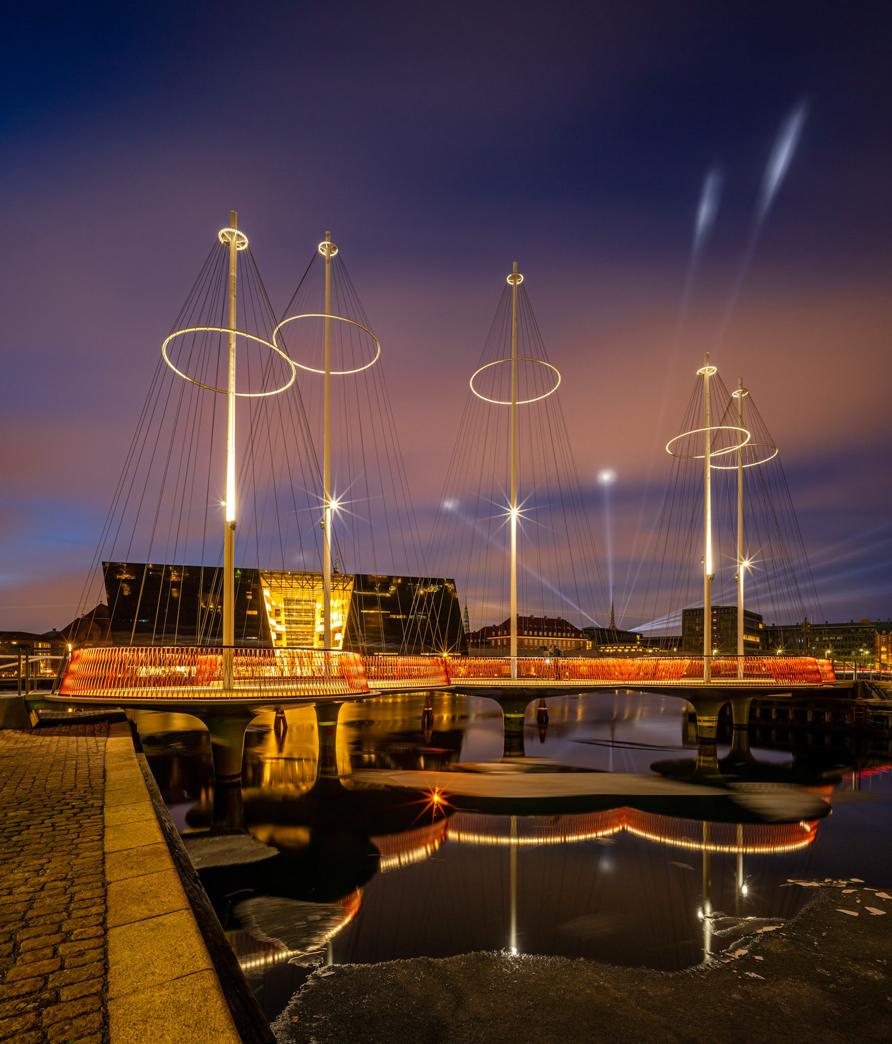 Laserbeams behind Bersen Tower lights up Copenhagen during the annual Lightfestival as seen from the "Cirkelbroen"