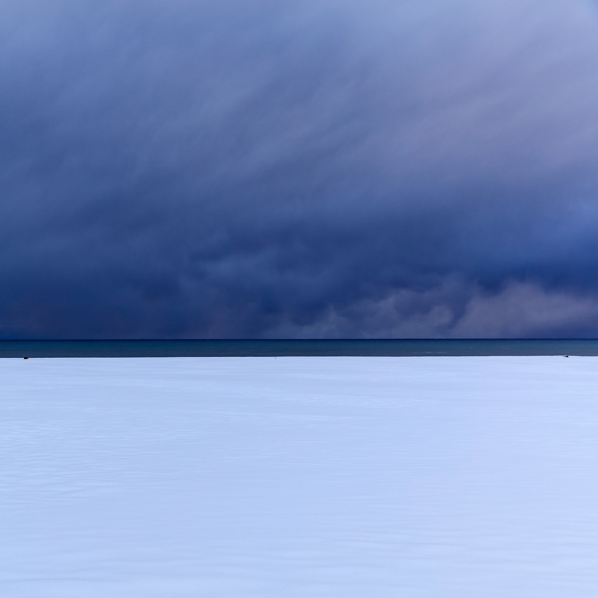 Storm over the Atlantic Occean approaches the snow covered coast of Iceland