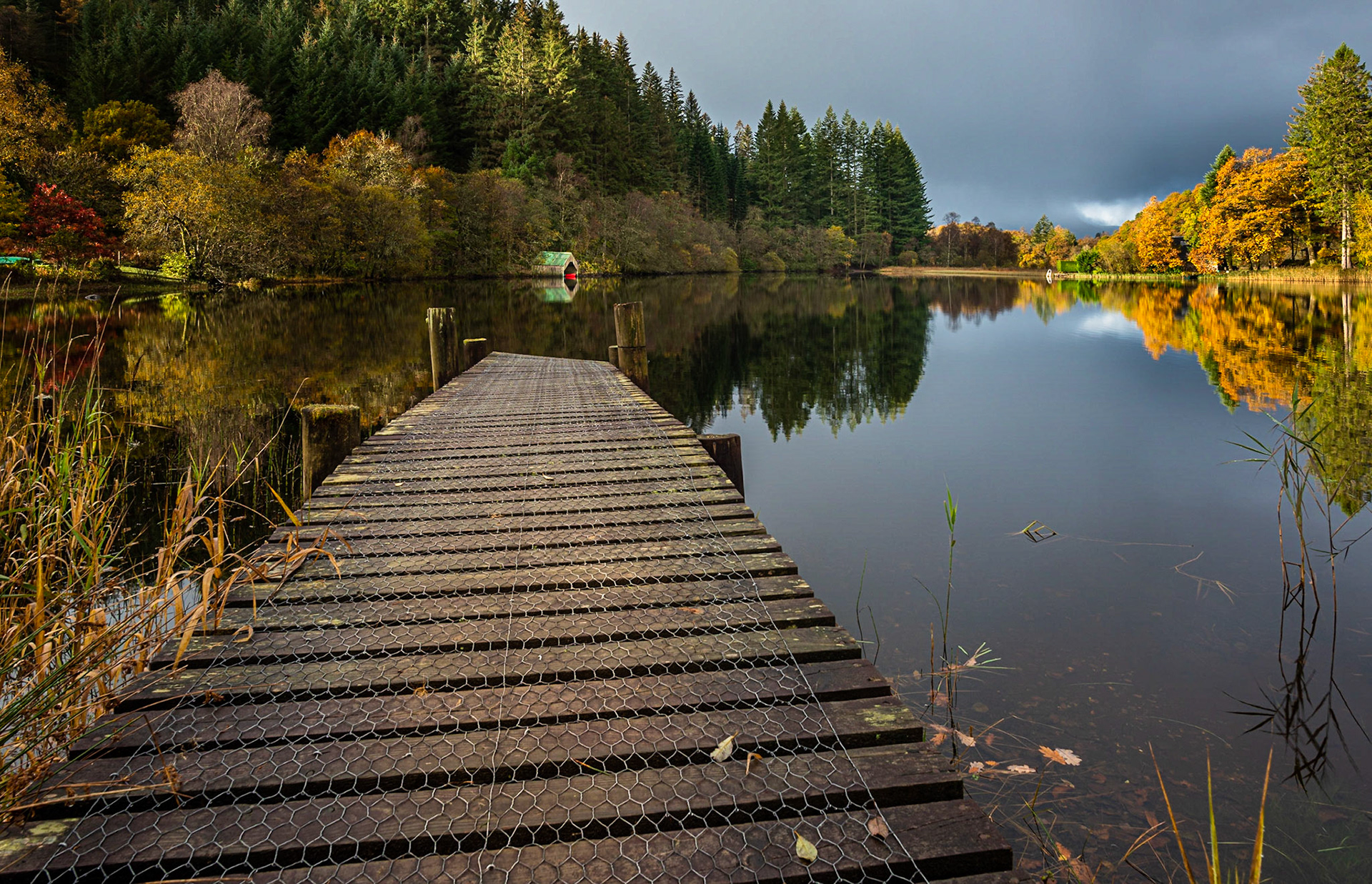 A  Red Boat in the Old Boathouse on Loch Ard in the Trossachs National Park on a stormy autumnal day