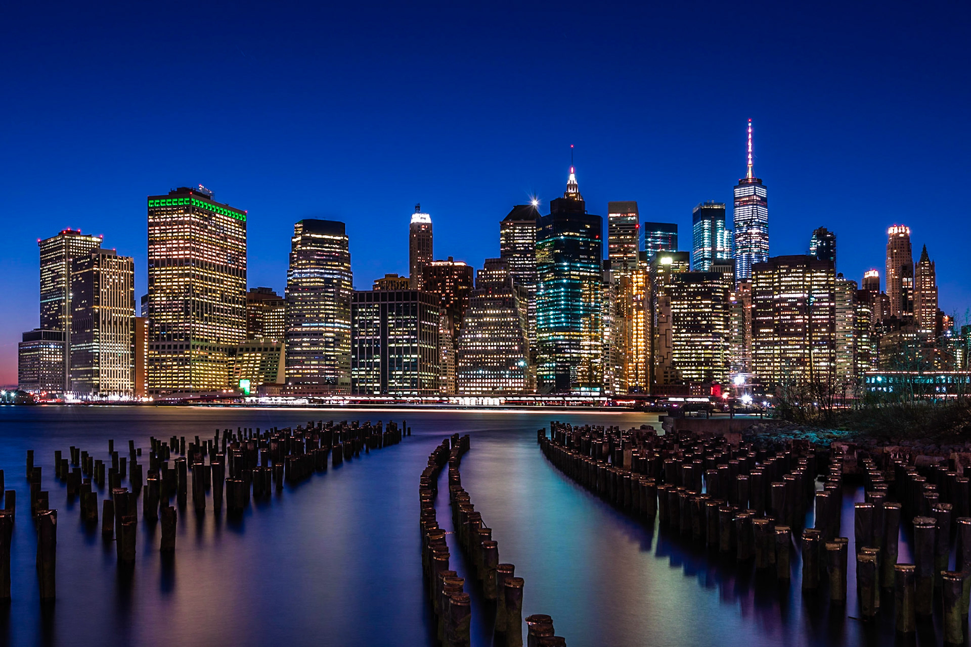 The NYC Skyline looking across from Brooklyn Bridge Park through the remains of the old piers