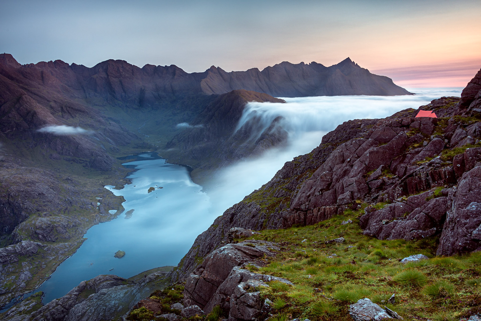 Sunrise at a Wild camp on the hills above Loch Coruisk on Skye with a cloud inversion flooding into  the glen below