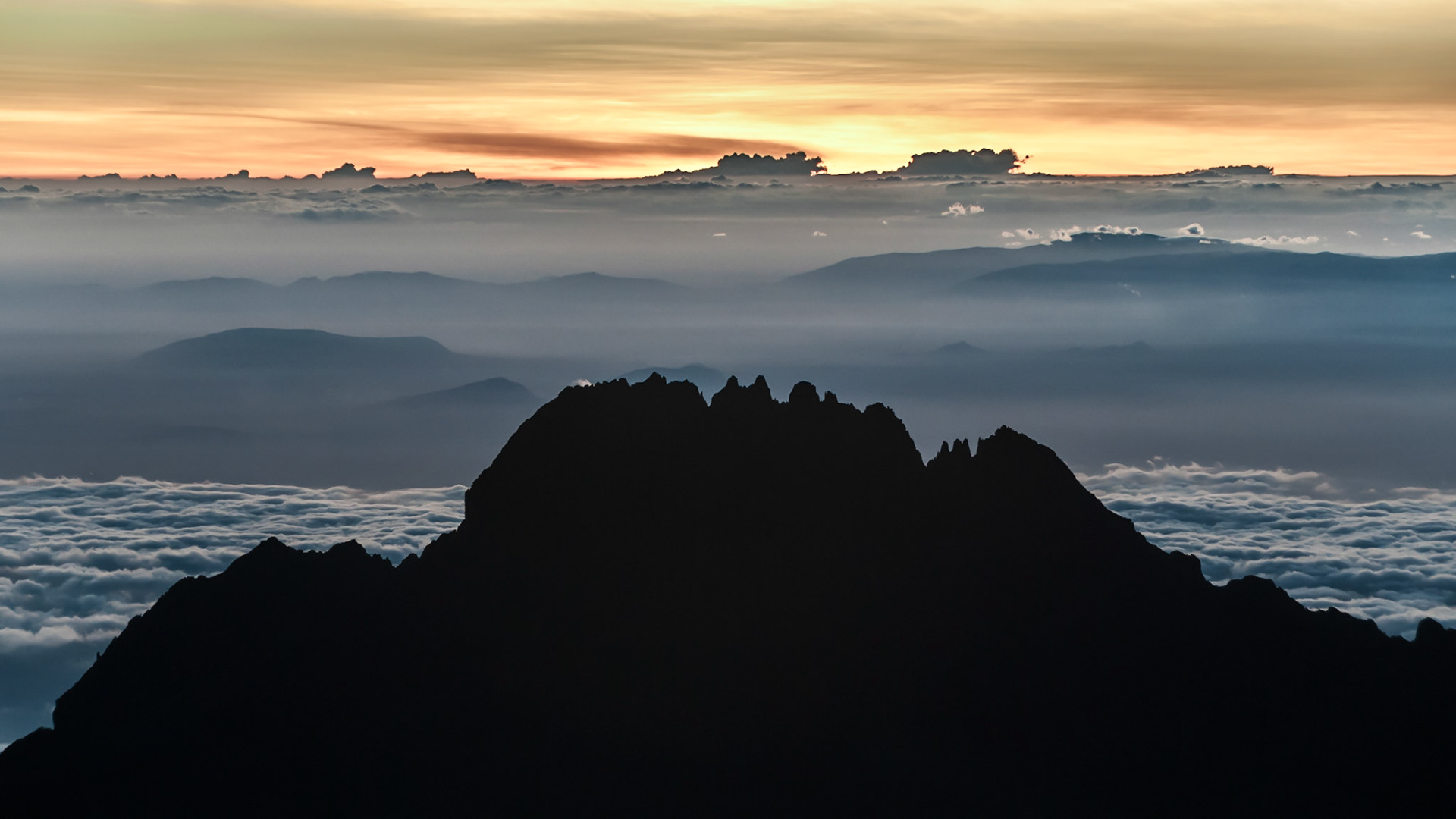 The early morning sun rising over Mawenzi looking back from the summit of Kilimanjro