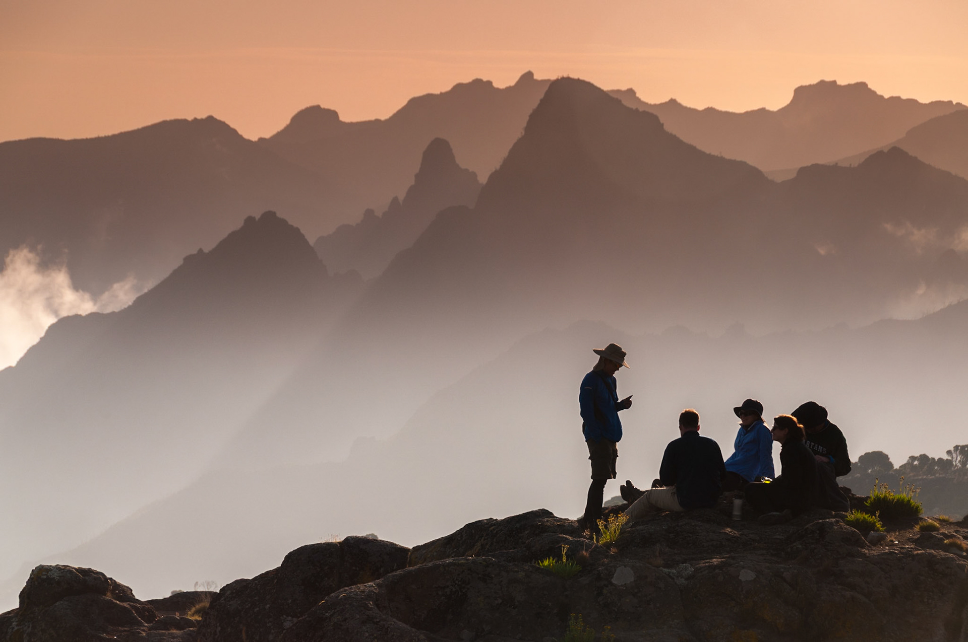 A group of trekkers relaxing on Shira Plateau at sunset