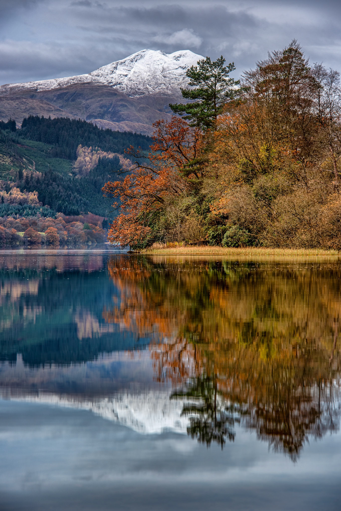 Looking across Loch Ard in the Scottish Highlands to the snowy summit of Ben Lomond
