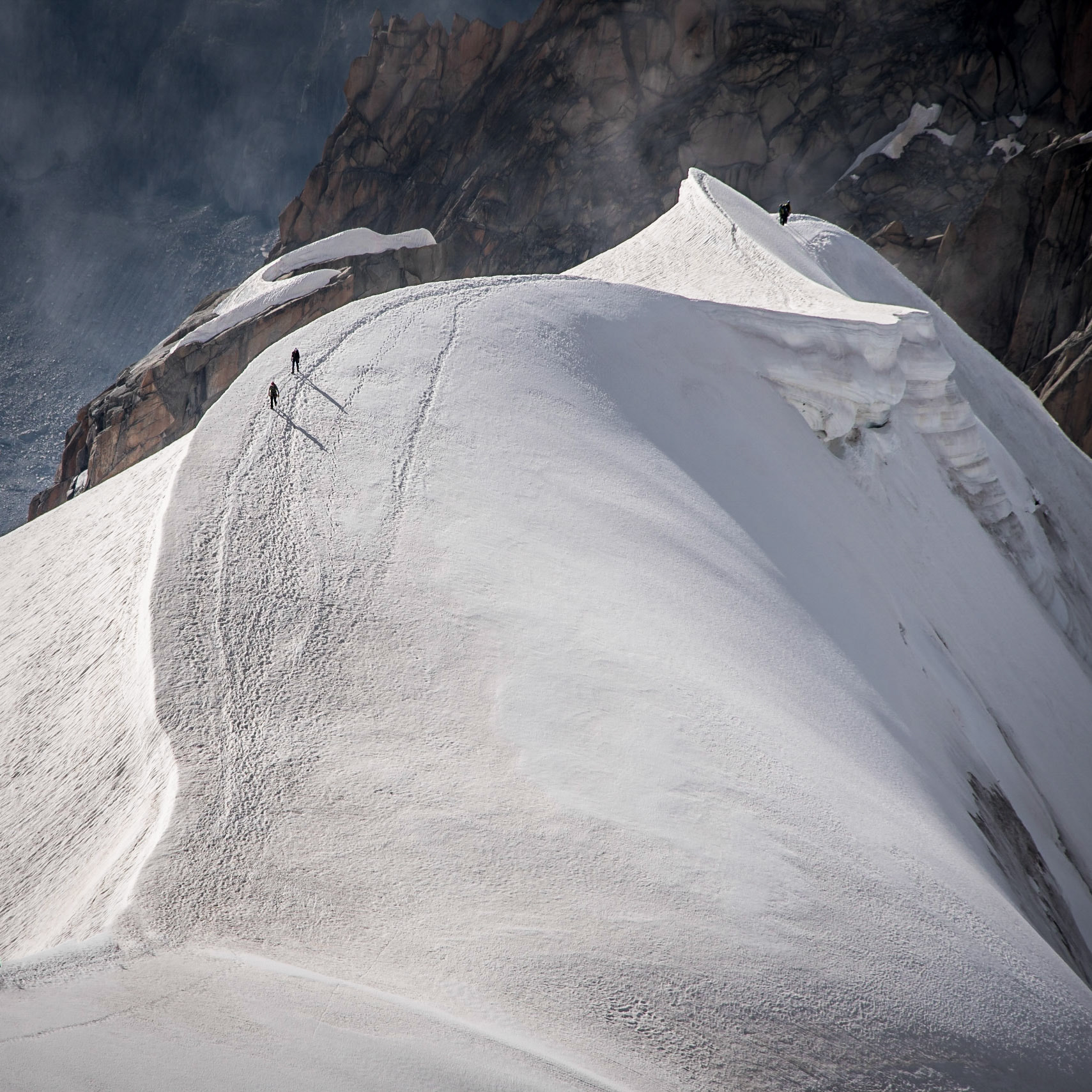 Looking down the ridge into the Vallee Blanche where a small group of climbers can be seen heading into the Vallee below