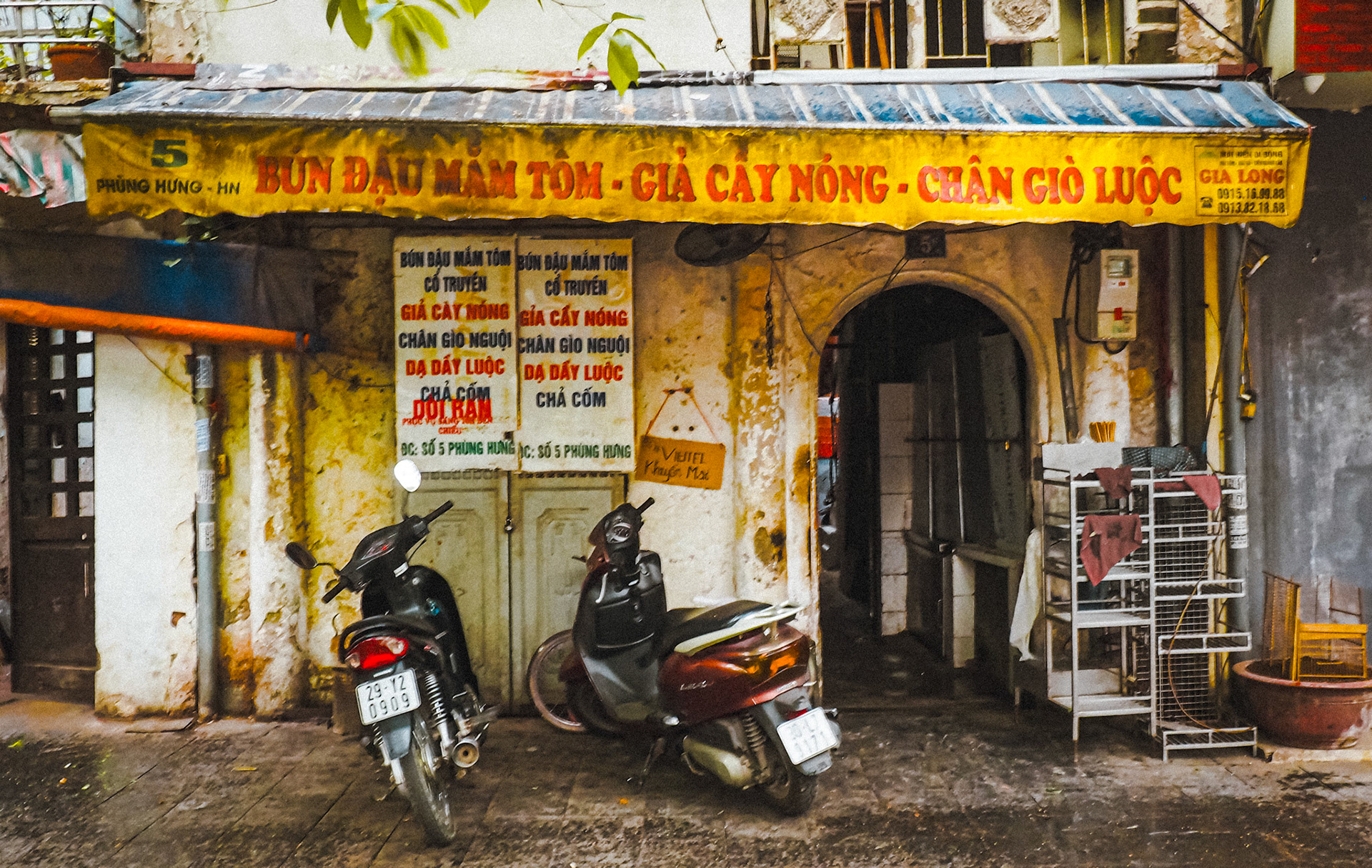 motorbikes in front of store with yellow awning