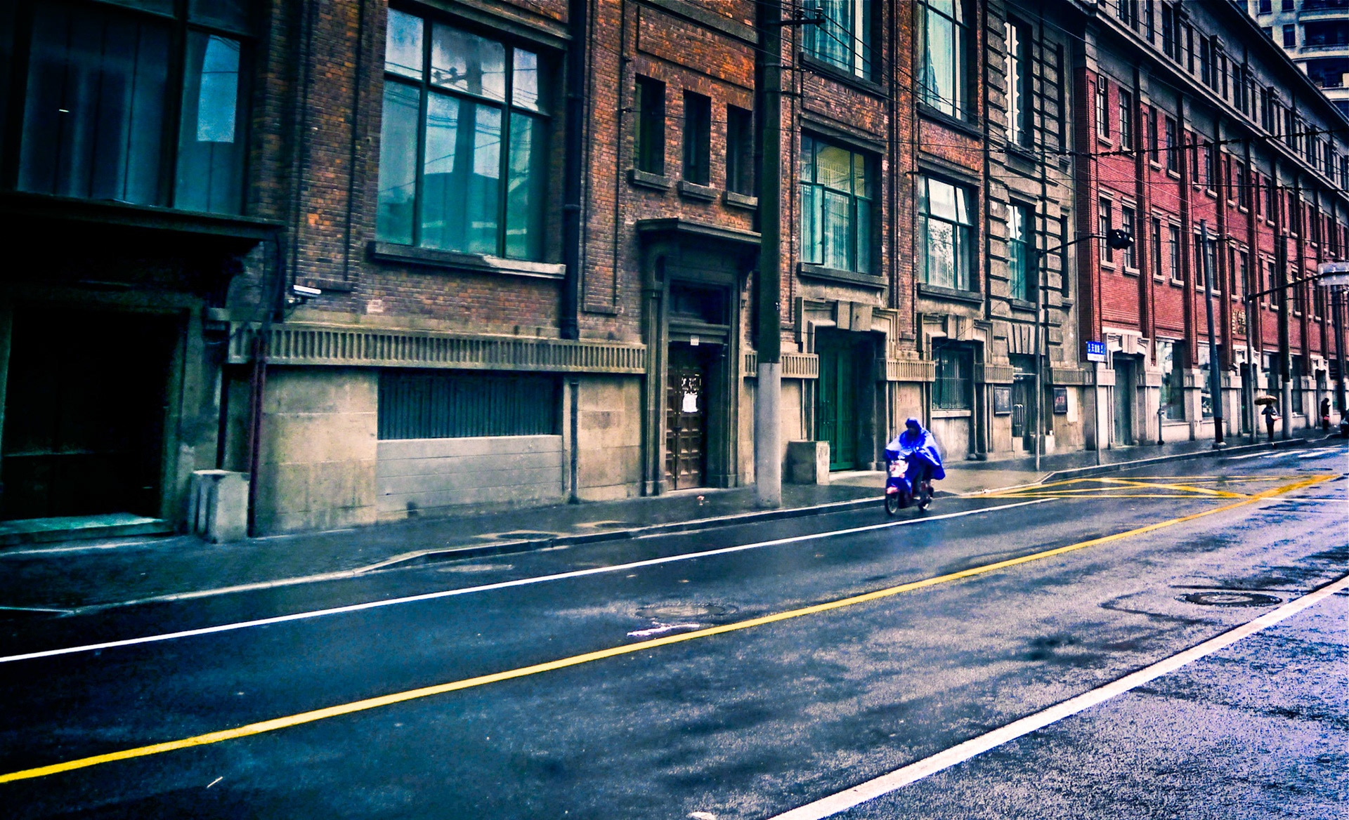 shanghai street scene in the rain. wet streets