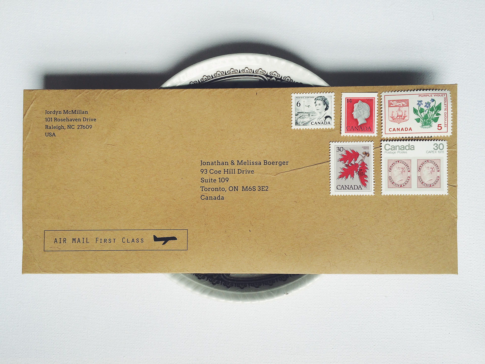 Custom envelope close up on top of china bowl