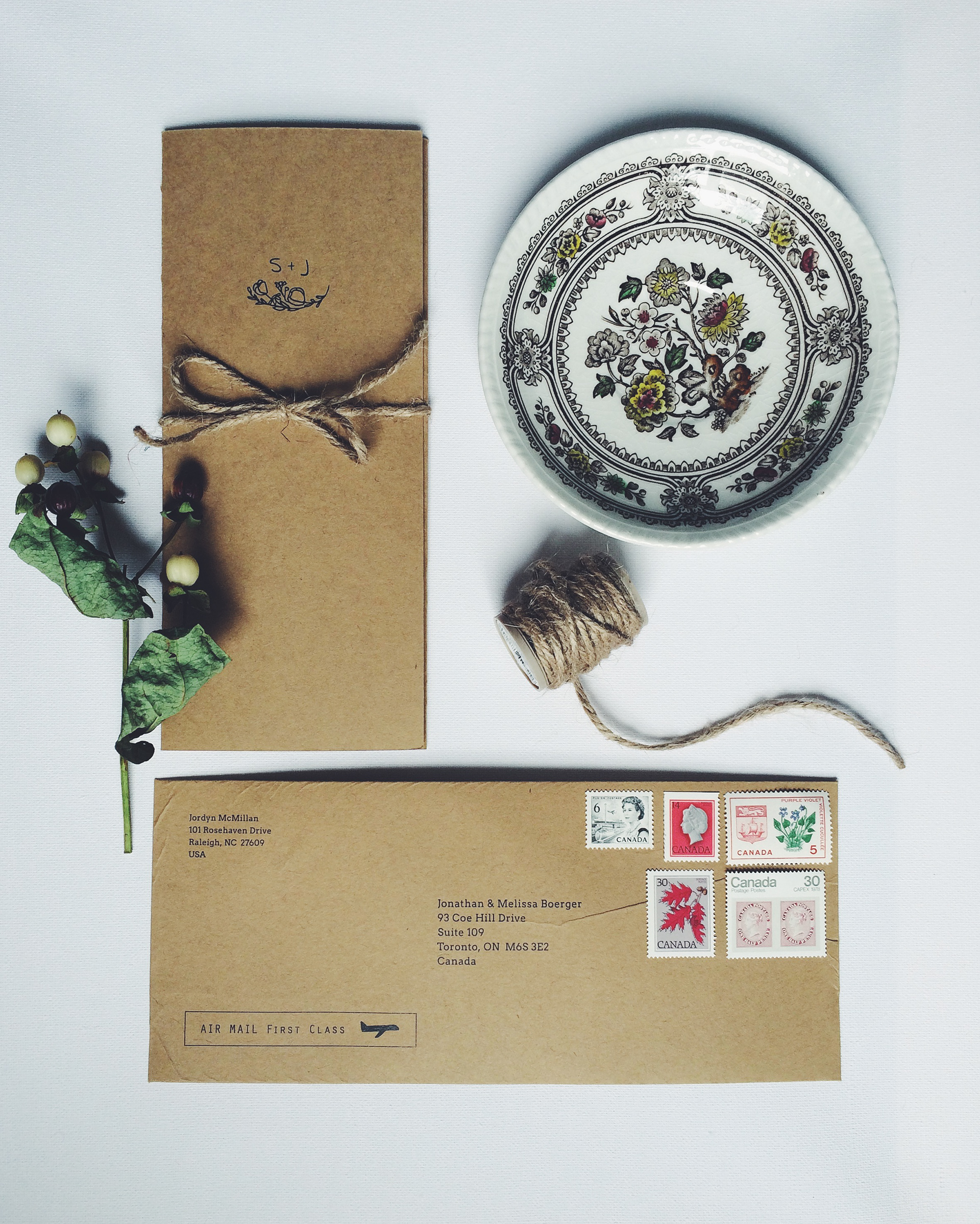 Folded and tied invitation with twine, a china bowl, and custom envelope