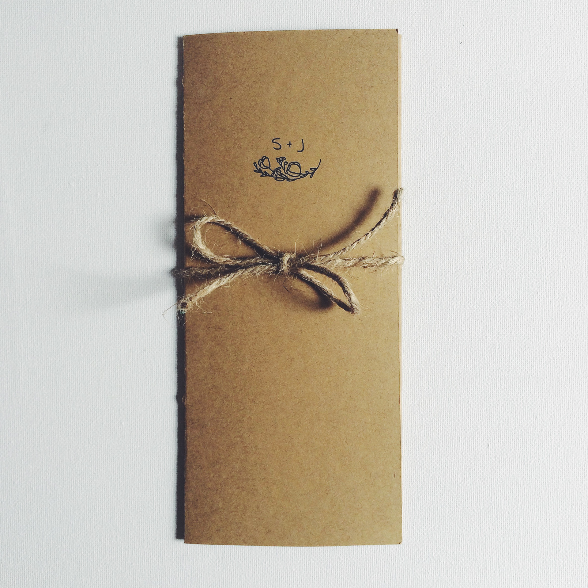 Isolated custom invitation featuring S + J monogram and flower illustration