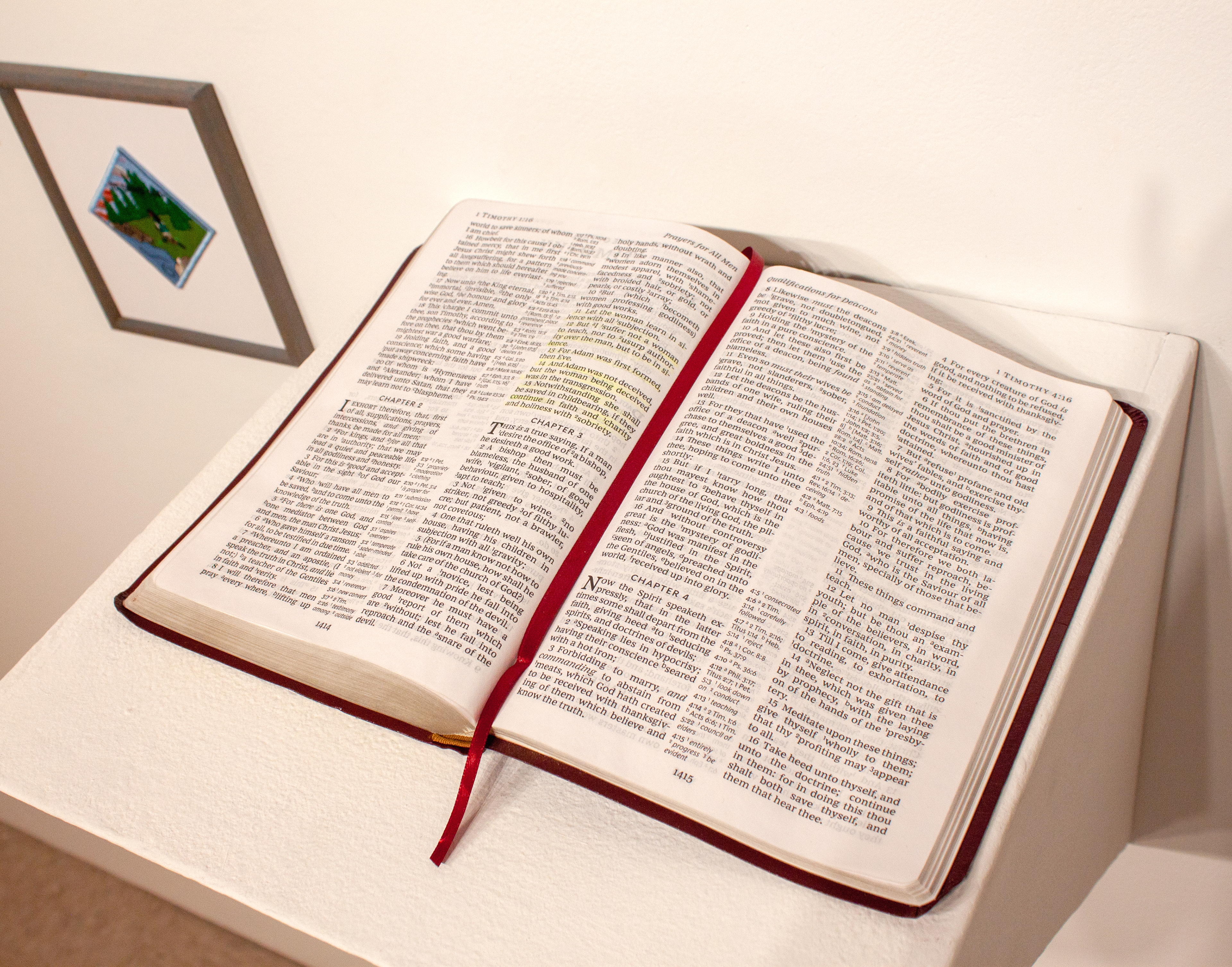 Bible open to 1 Timothy 2:11-15, highlighted