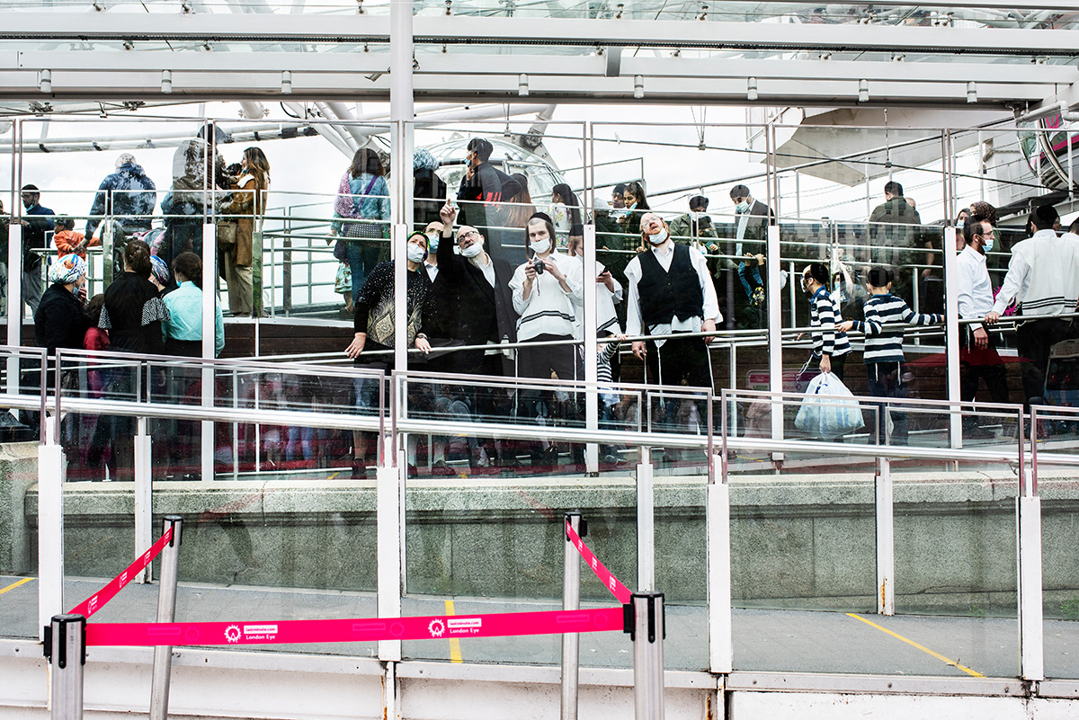 Group of Orthodox Jews at the London Eye, South London.  After months of closures and in the attempt to recover the tourism sector, from the 1st of August, tourist attractions started to reopen.