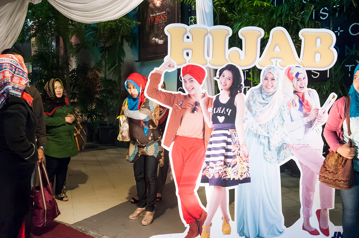 Women posing at the entrance of the Gala Premiere of the movie “Hijab”, XXI Epicentrum, Jakarta. The movie, a comedy about four  friends that start a hijab fashion business and become more successful than their husbands, is the representation of the new urban society in Jakarta and of how the hijab has reached the middle class.