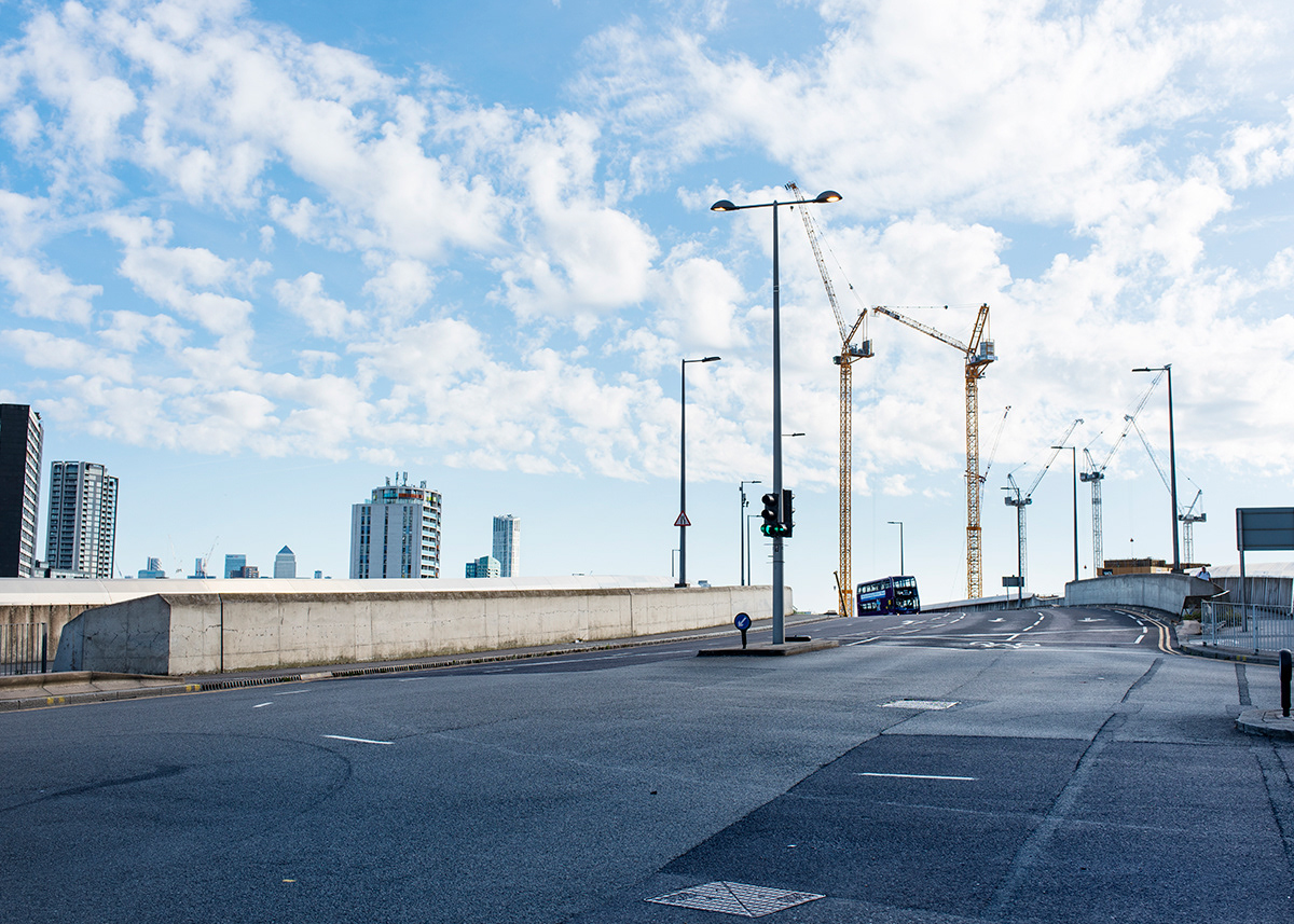 Deserted street with cranes in the background,Stratford, London.  More construction sites re-opened since Boris Johnson announced the first steps towards lifting the UK’s lockdown, although some in the sector never stopped. During the lockdown the Government encouraged the industry to continue work on sites, but the shortages of materials caused the suspension of some projects.