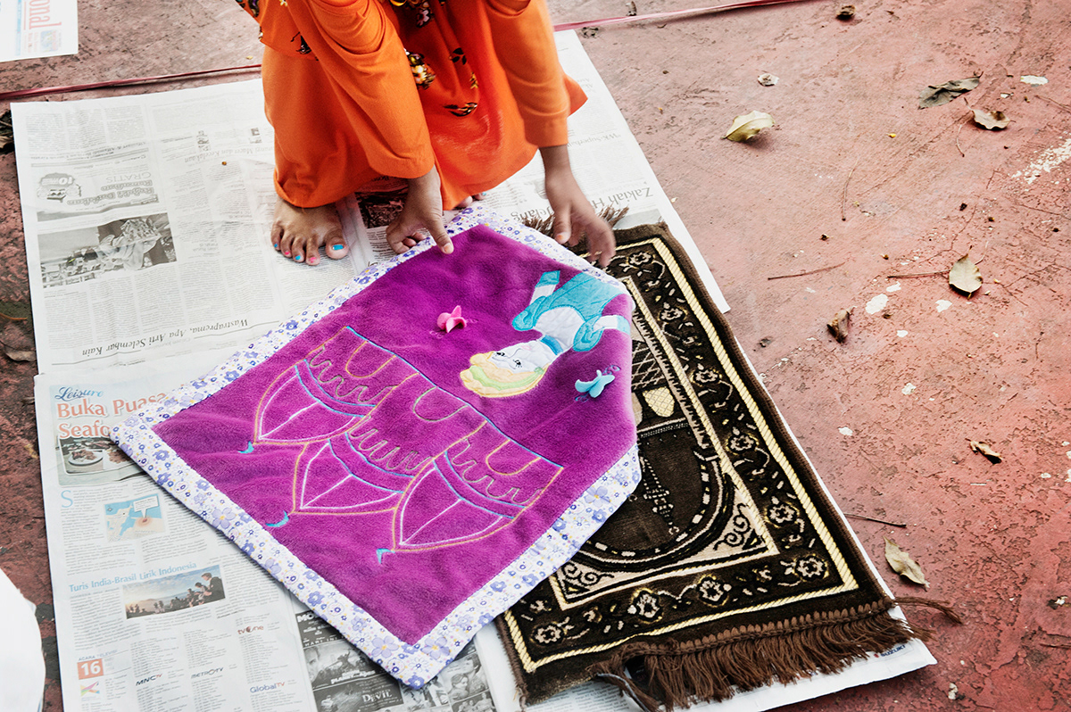  Little girl getting ready for Eid prayer. Al Azhar mosque, Jakarta