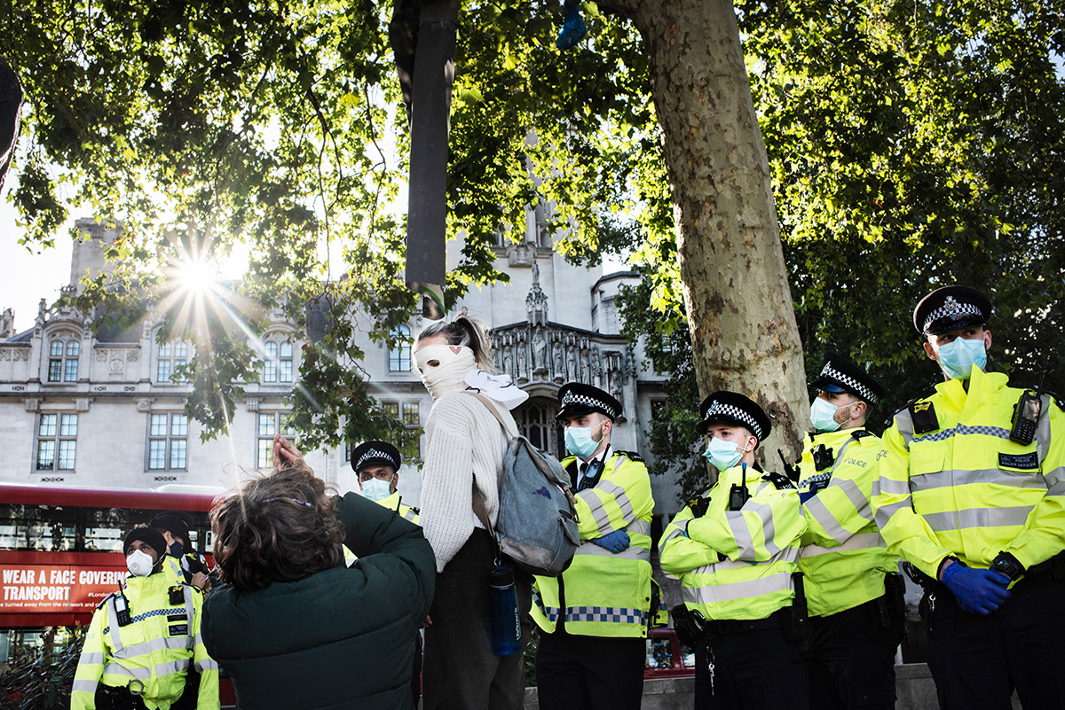Extincion Rebellion protests in front of a police cordon, Parliament square, London.  After being placed on hold by the corona virus pandemic, the environmental campaign group with the ease of lockdown measures started five days of protests around the country. In the attempt to put pressure on the Government over climate change issues, before to return to “business as usual”.