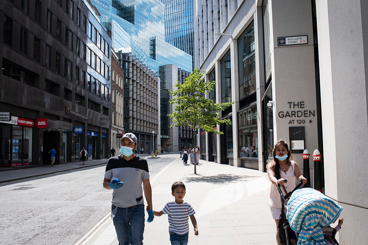 Family having a stroll in empty Fenchurch street in a week day, City of London Financial District, London.