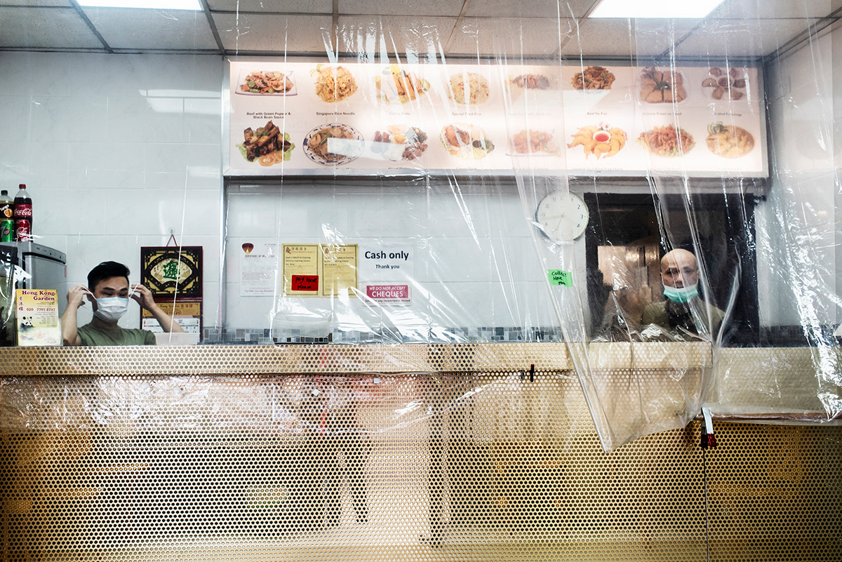 Chinese takeaway, Peckham, South London. With the reopening of non essential shops, the Government encouraged the use of safety measures including plastic screens at the tills and floor markings to keep shoppers two metres apart.