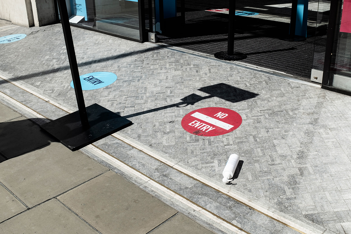 Hand sanitiser bottle on the floor at the entrance of a big retail shop, Oxford street, Central London.