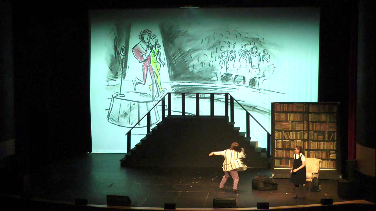 Charcoal sketch of happy performers embracing, projected onto a screen during the live performance of Matilda The Musical, celebrating the joyful news of pregnancy.