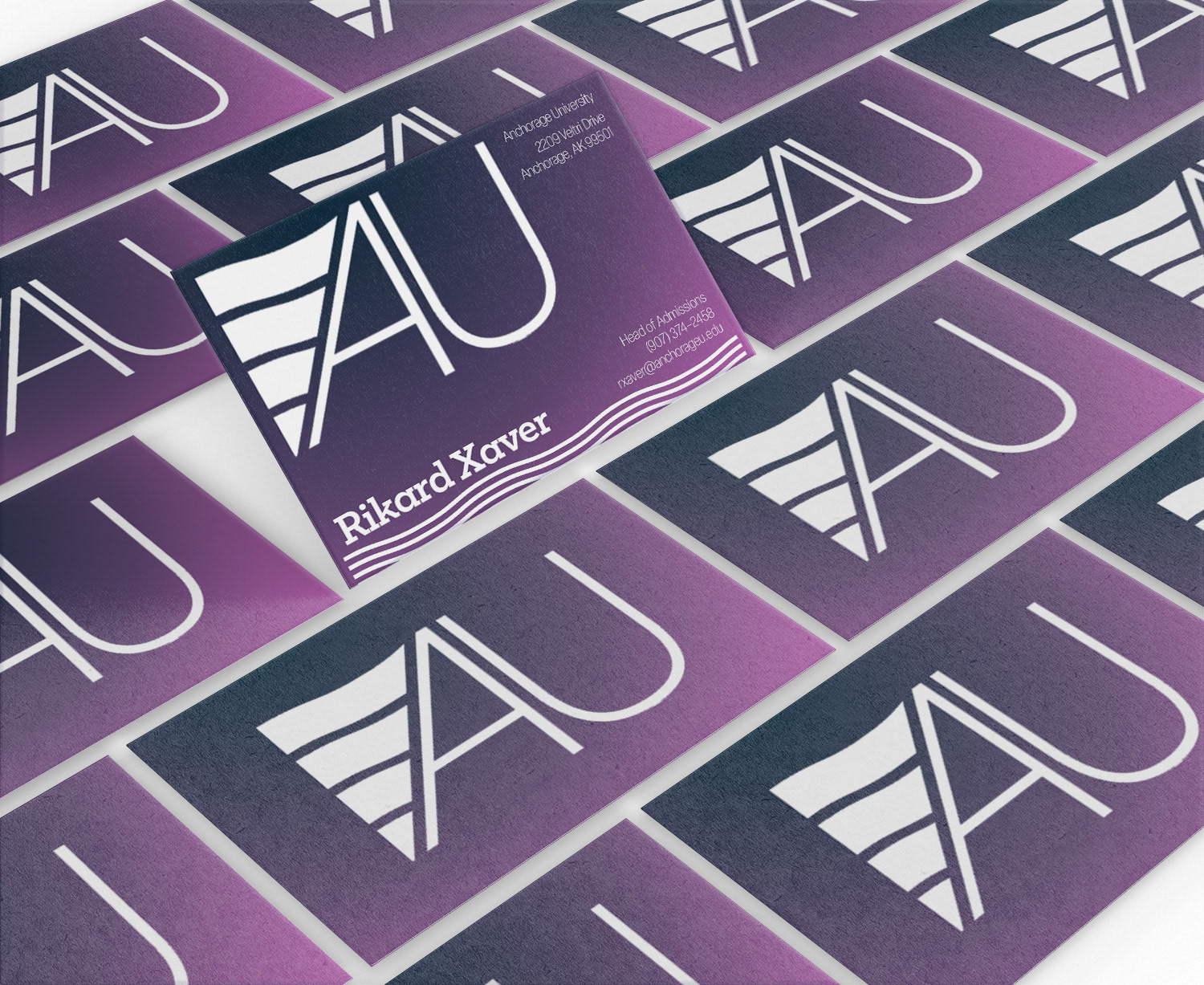 Pink and blue business cards with the Anchorage University logo on them