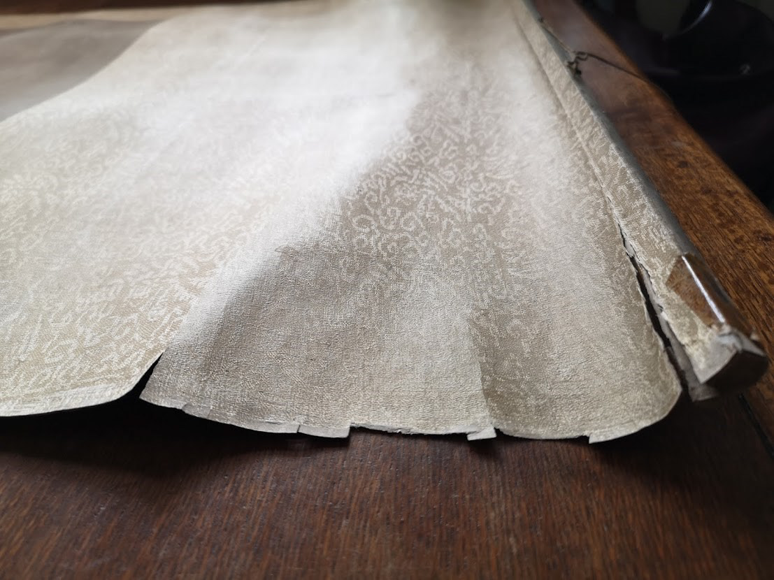 Details of scroll condition with tears and some missing area, image before conservation