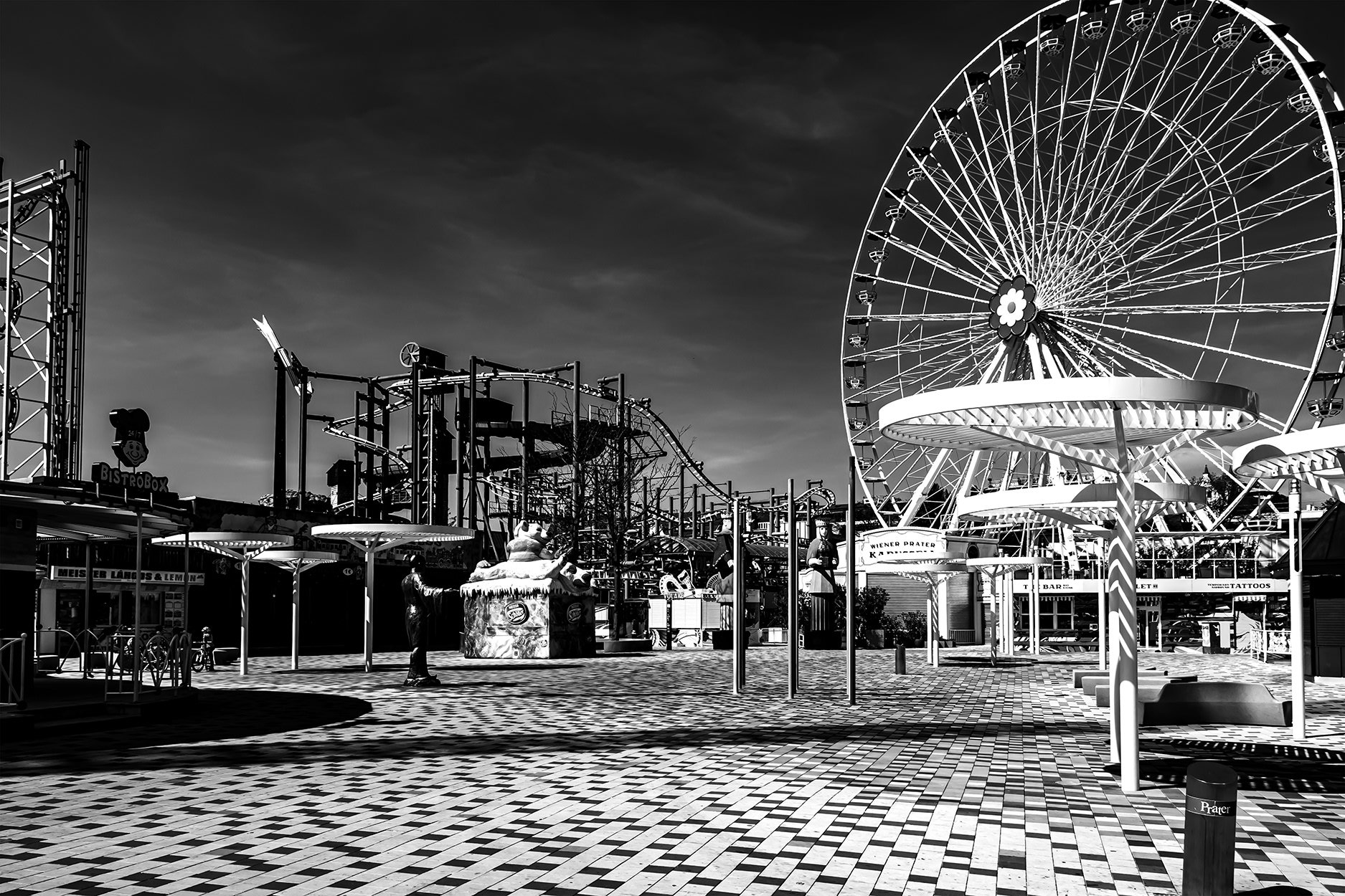 Empty Vienna Prater amusement park during the 2020 COVID-19 lockdown – Ferris wheel and rides without visitors under dramatic sky