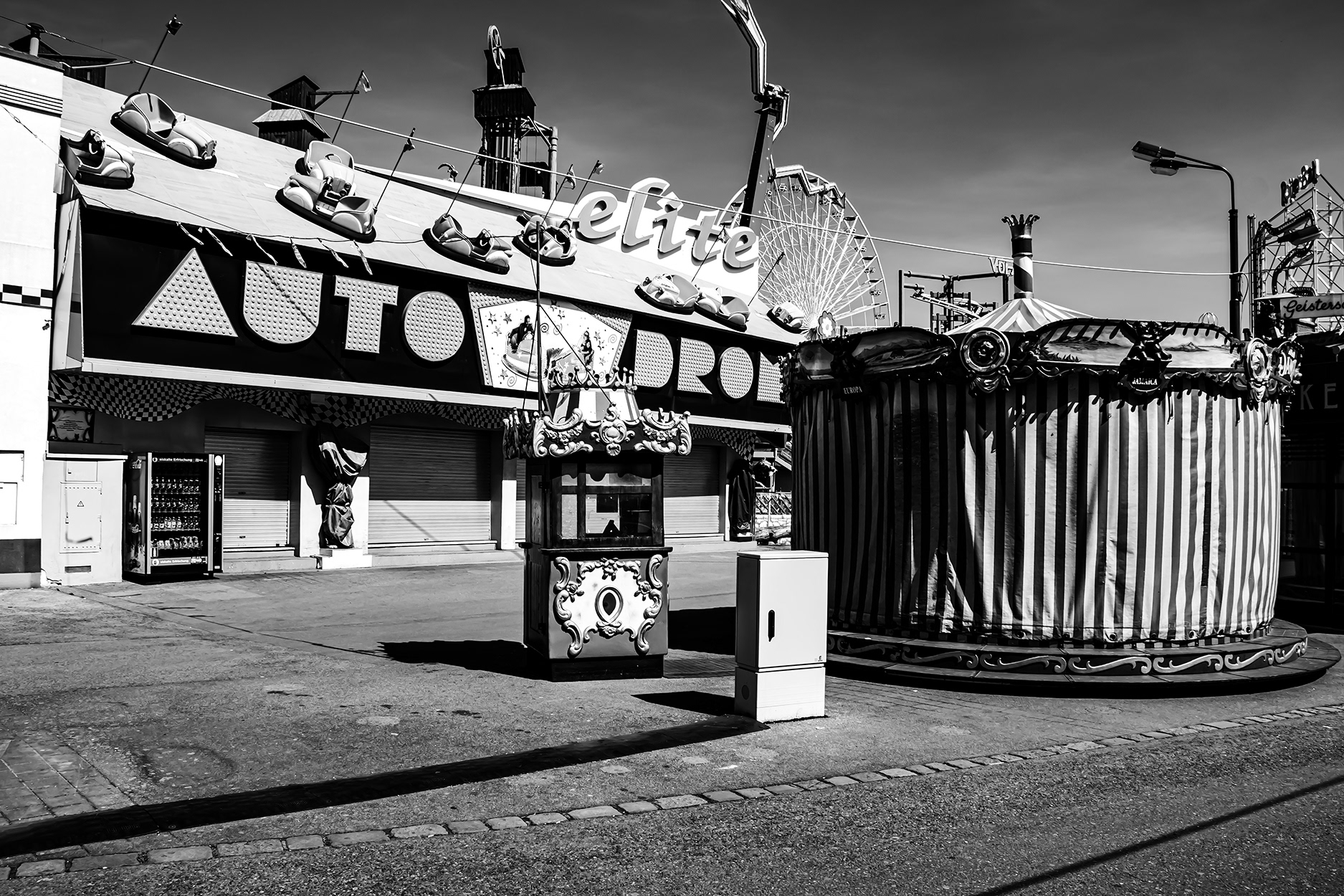Closed amusement park at Vienna Prater during the 2020 COVID-19 lockdown – empty fairground with Ferris wheel and shuttered attractions, no visitors