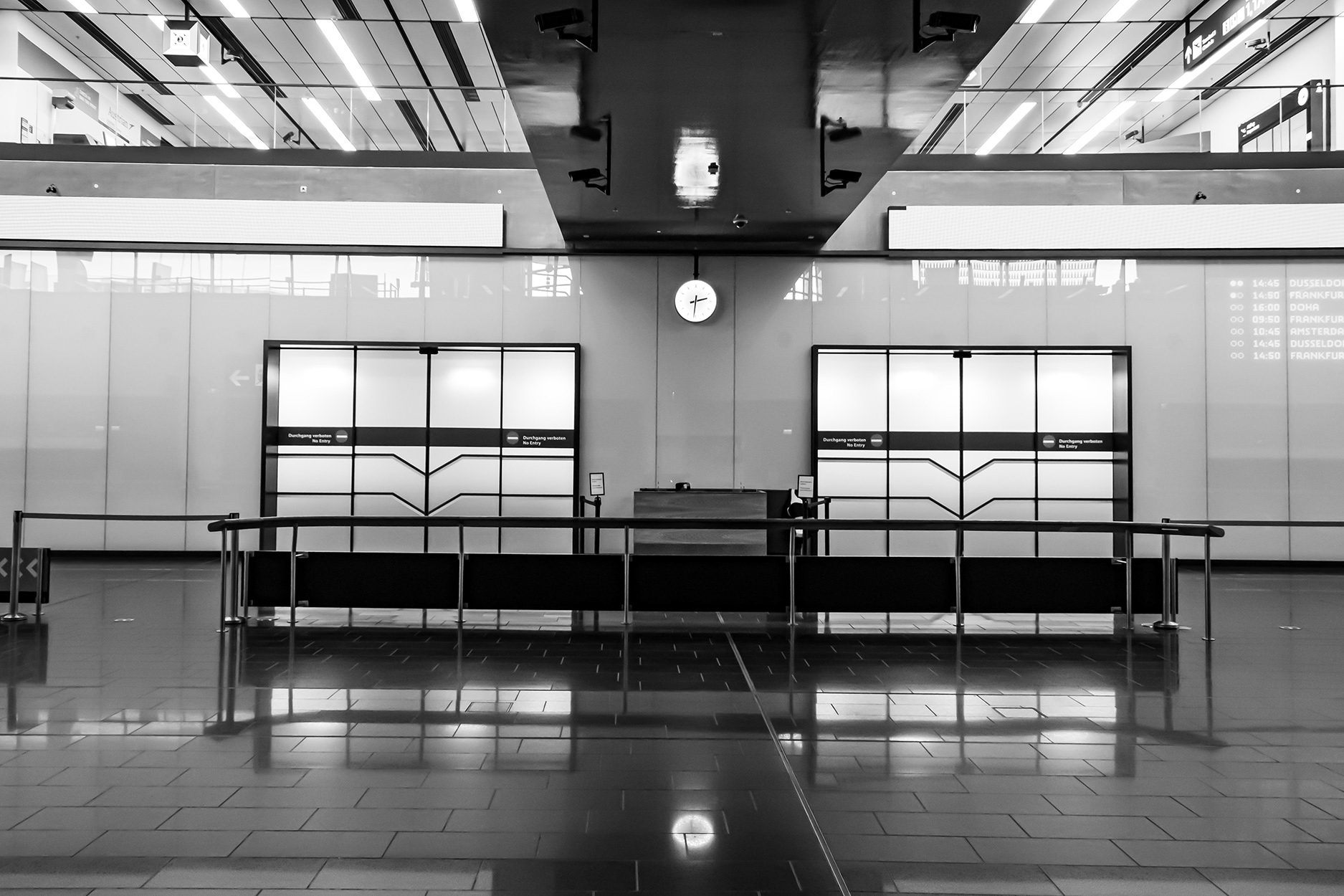 Empty check-in area at Vienna International Airport during the 2020 COVID-19 lockdown – deserted terminal with self-service kiosks and no passengers