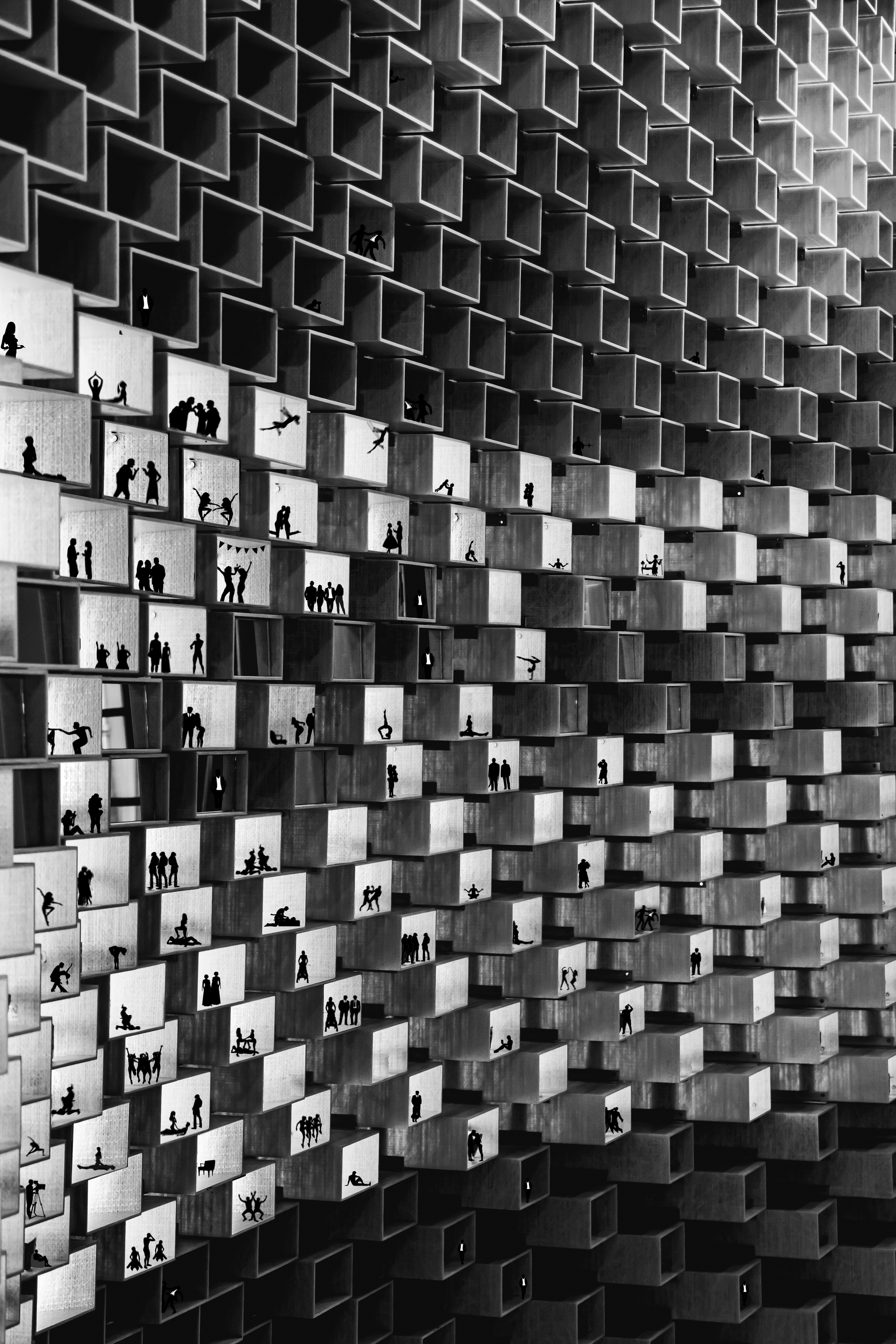 black and white fine art photography with geometric  building and small silhouettes.