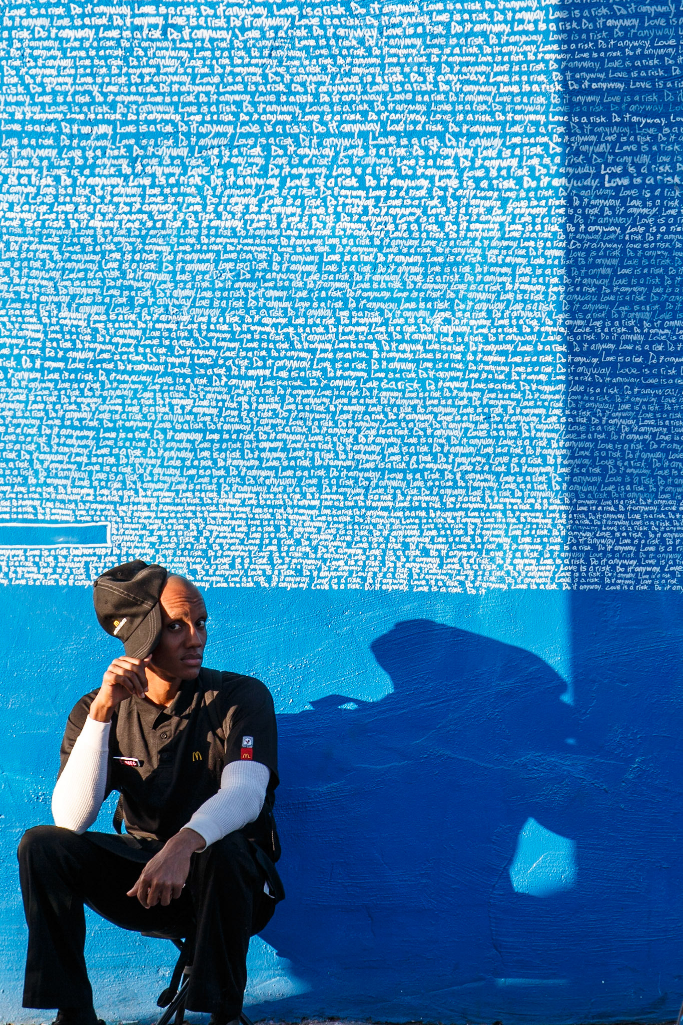 Artist taking a break while creating artwork on a Wynwood wall