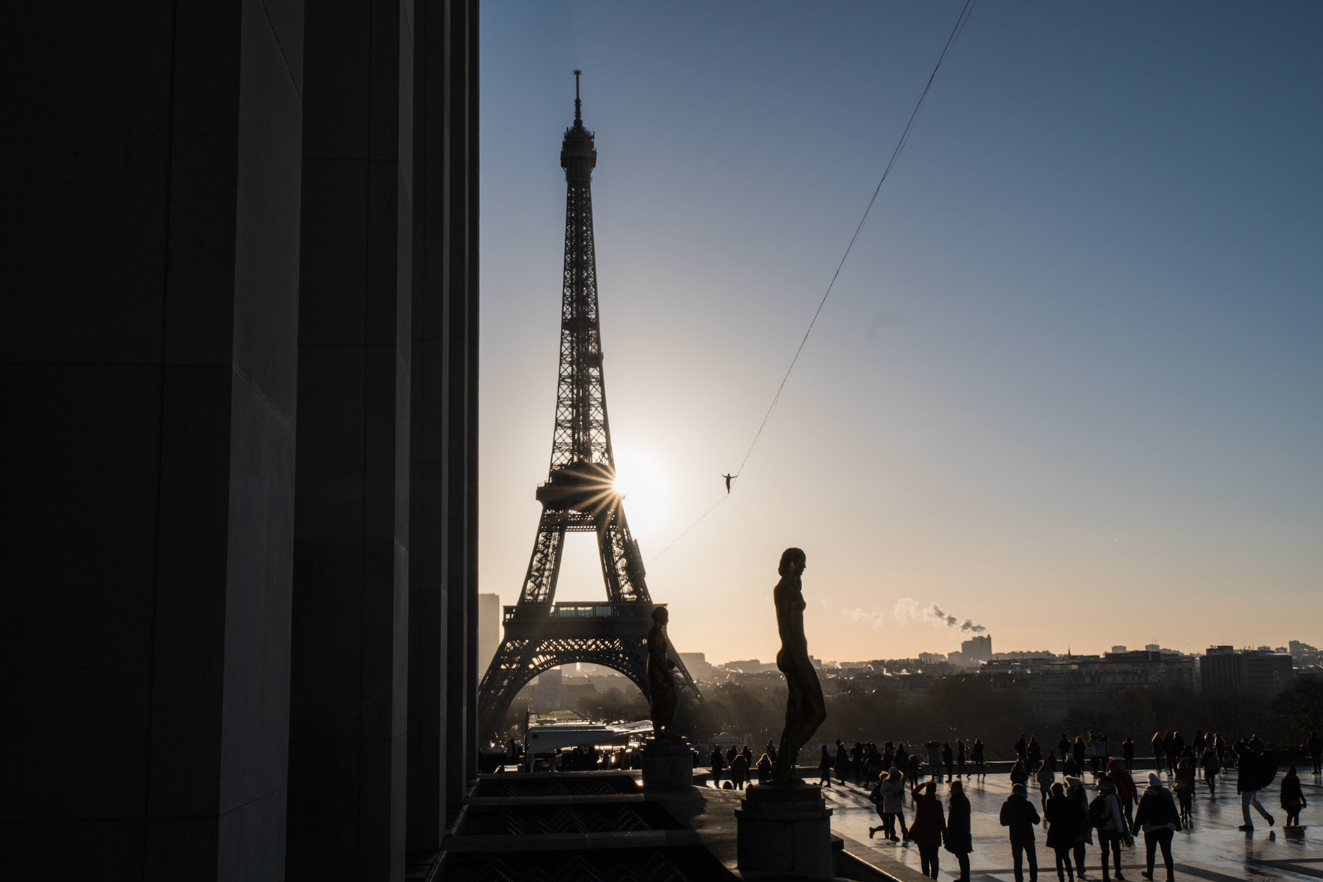 PARIS, FRANCE - DECEMBER 09: A man walk on a highline between eiffel tower and trocadero with people around, ÎLe de france, Paris, France on December 9, 2017 in Paris, France. (Photo by Fred Marie/Art in All of Us/Corbis via Getty Images)