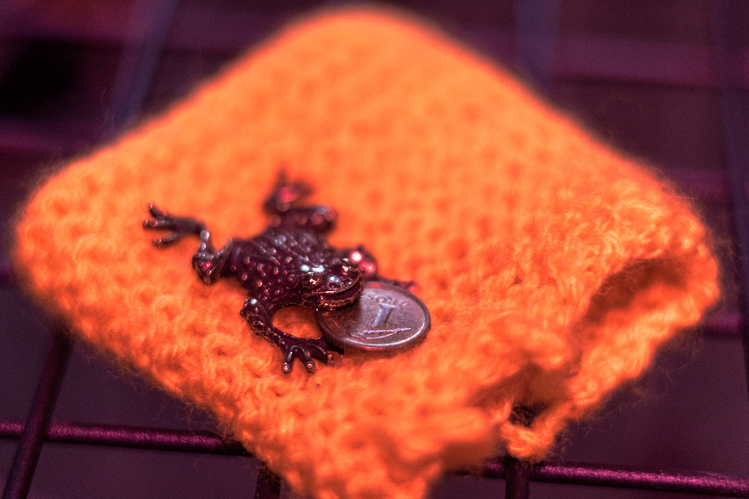 Monika Czyżyk, Frogo 1 Grosz on a bath towel, 2022, bronze, coin, wool thread, 1x 2cm