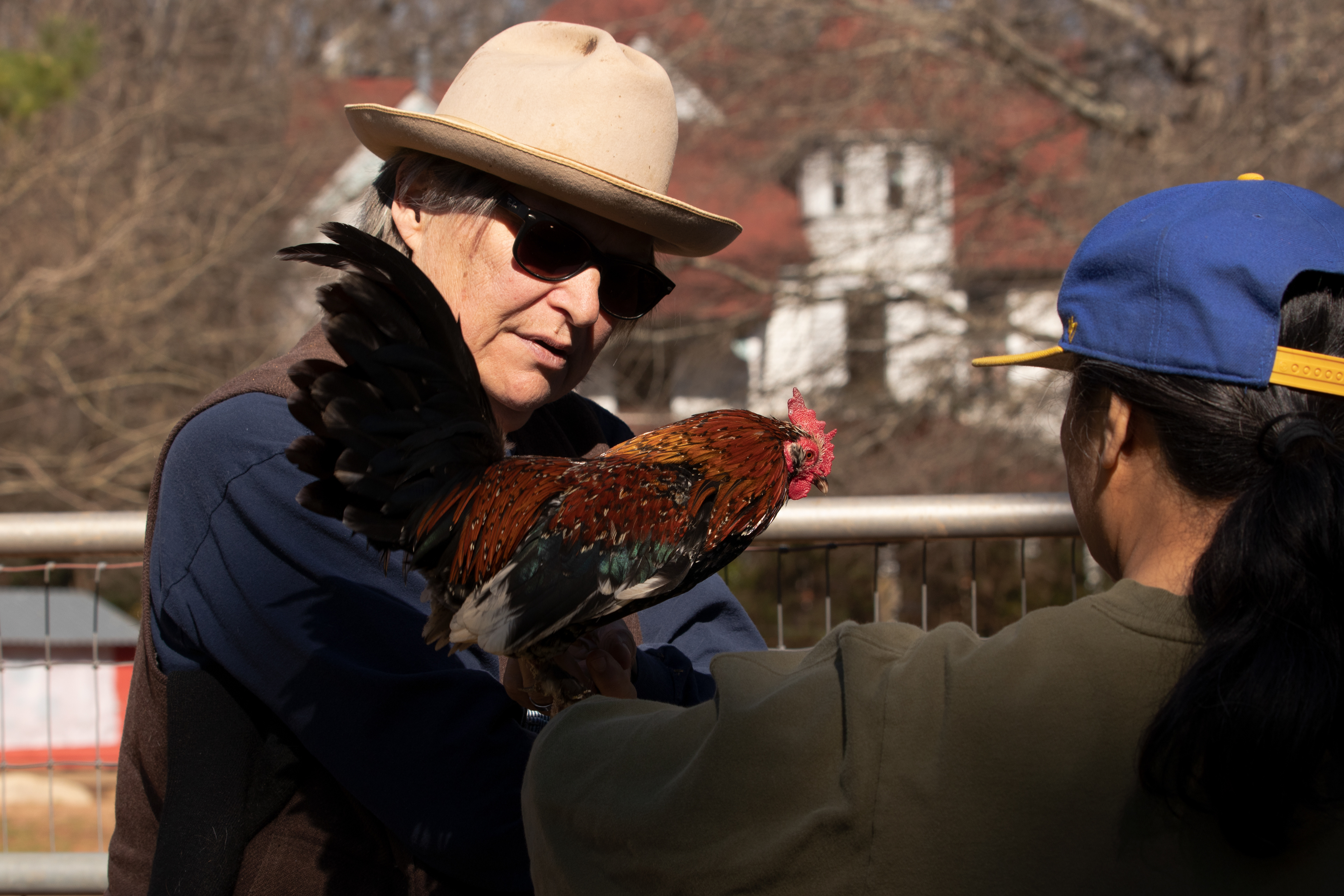 Sweet Olive Farm co-founder Kat Howkins lets a mom hold one of the chickens on March 20, 2022 in Winterville, Georgia. The mom brought her husband and three-year-old son to the farm to do a tour before the son’s birthday party there next week. Sweet Olive makes some of its money for feeding the animals by hosting events like birthday parties.