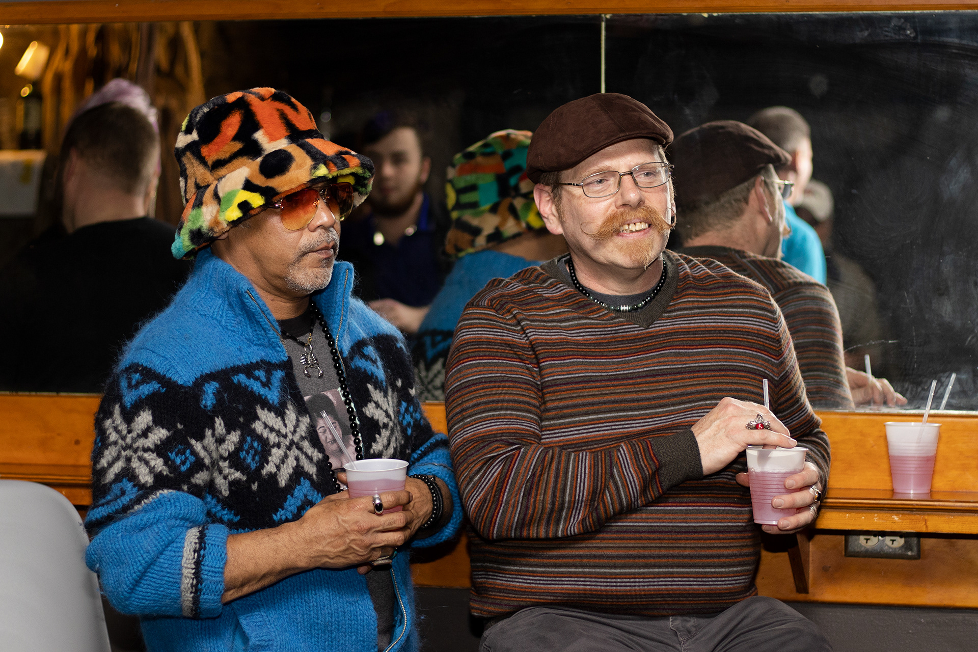 Two guests at the Athens Showgirl Cabaret show chat before the show starts in Athens, Georgia on March 18, 2022. Athens Showgirl Cabaret, founded in 2010, is a group of drag queens who perform throughout Athens and raise money for LGBTQ-related charities. (Photo/Julia Walkup)