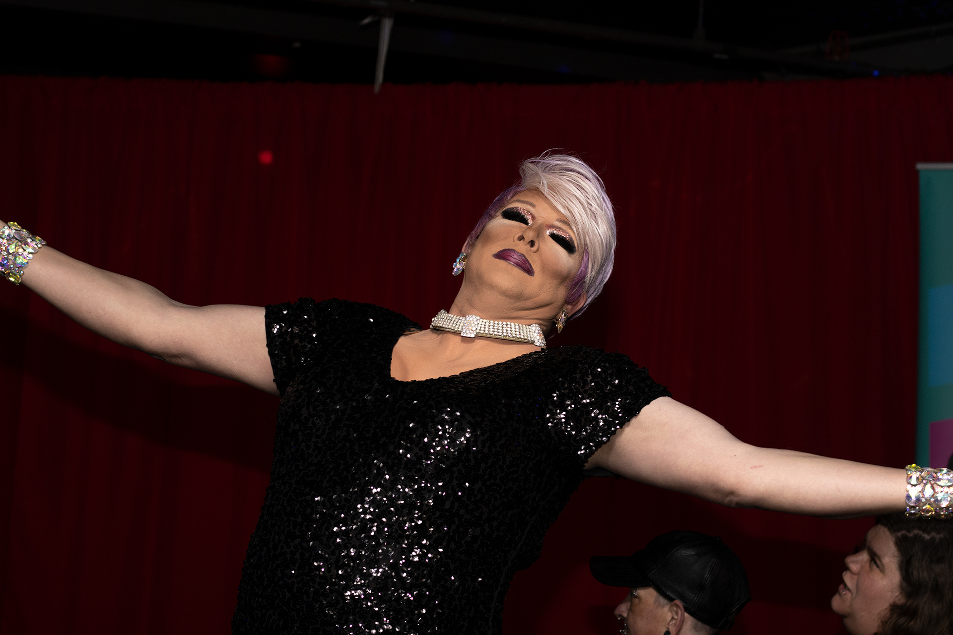 Drag queen Lori Divine spreads her arms at the beginning of her number at Athens Showgirl Cabaret’s show on March 18, 2022 at The Soundtrack in Athens, Georgia. Lori Divine was one of the hosts of the night, along with Kellie Divine. (Photo/Julia Walkup)