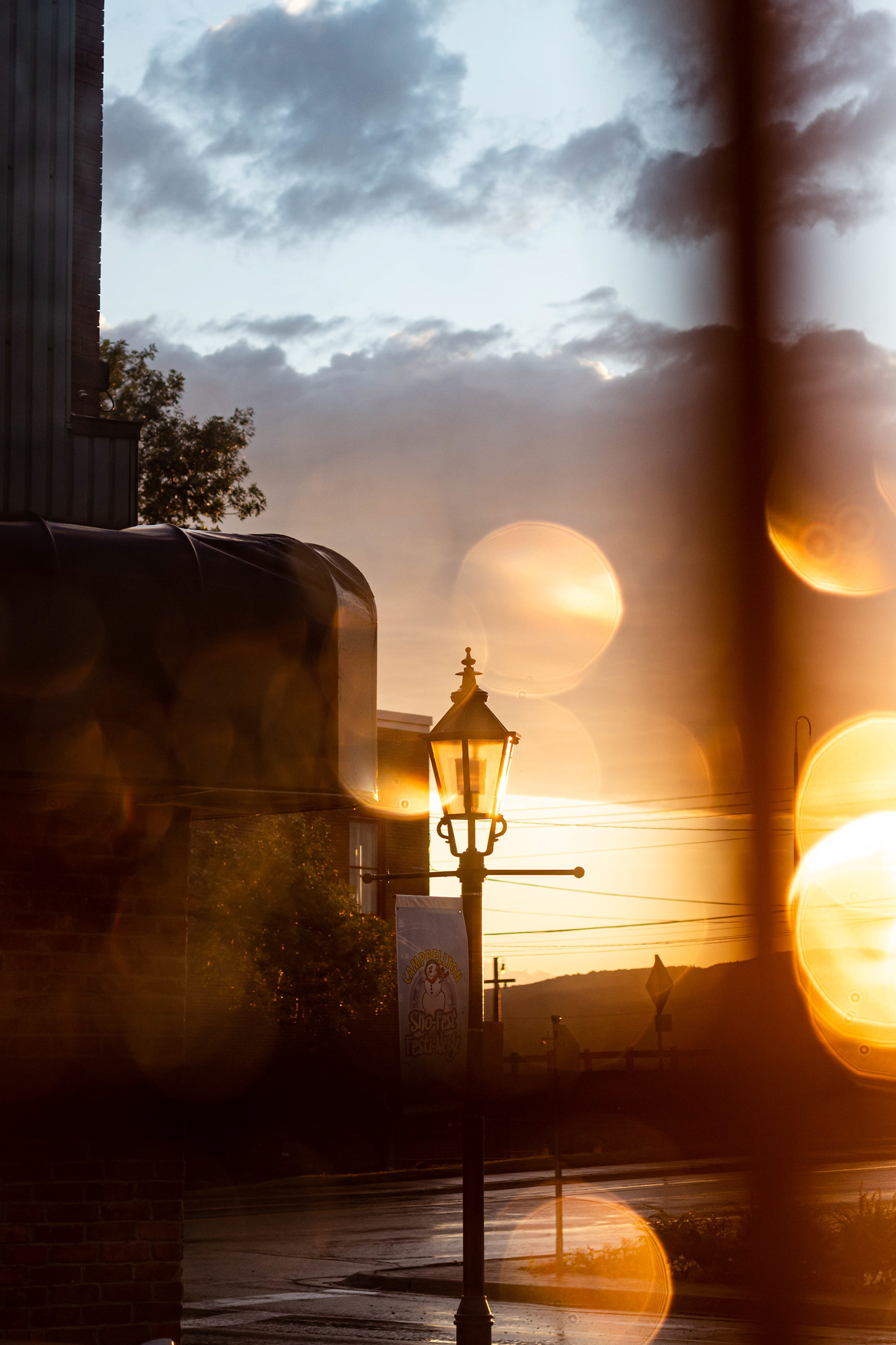 Street photography lamp post at sunset after rain