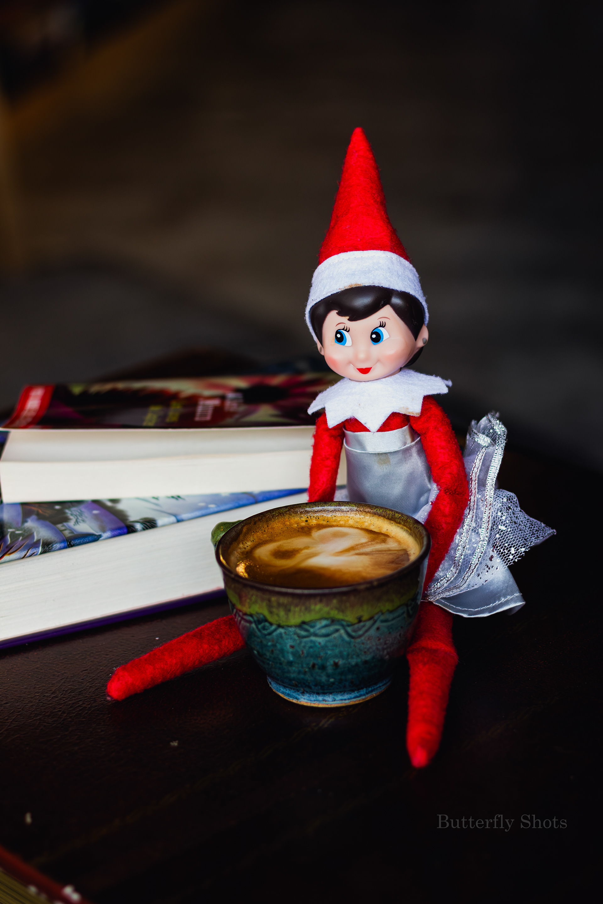 Product photography of a cortado coffee with an elf