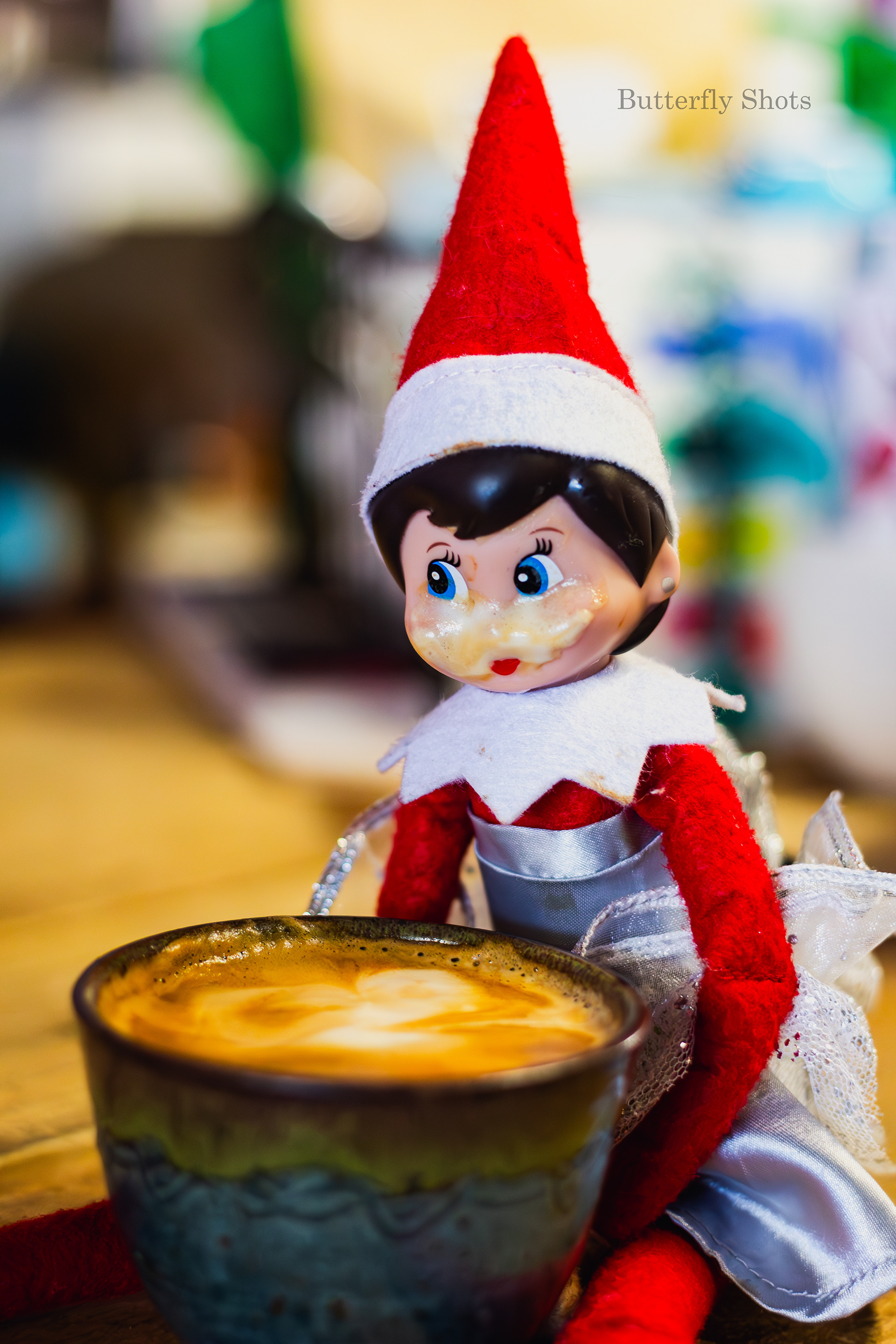 Product photography of a cortado coffee with an elf