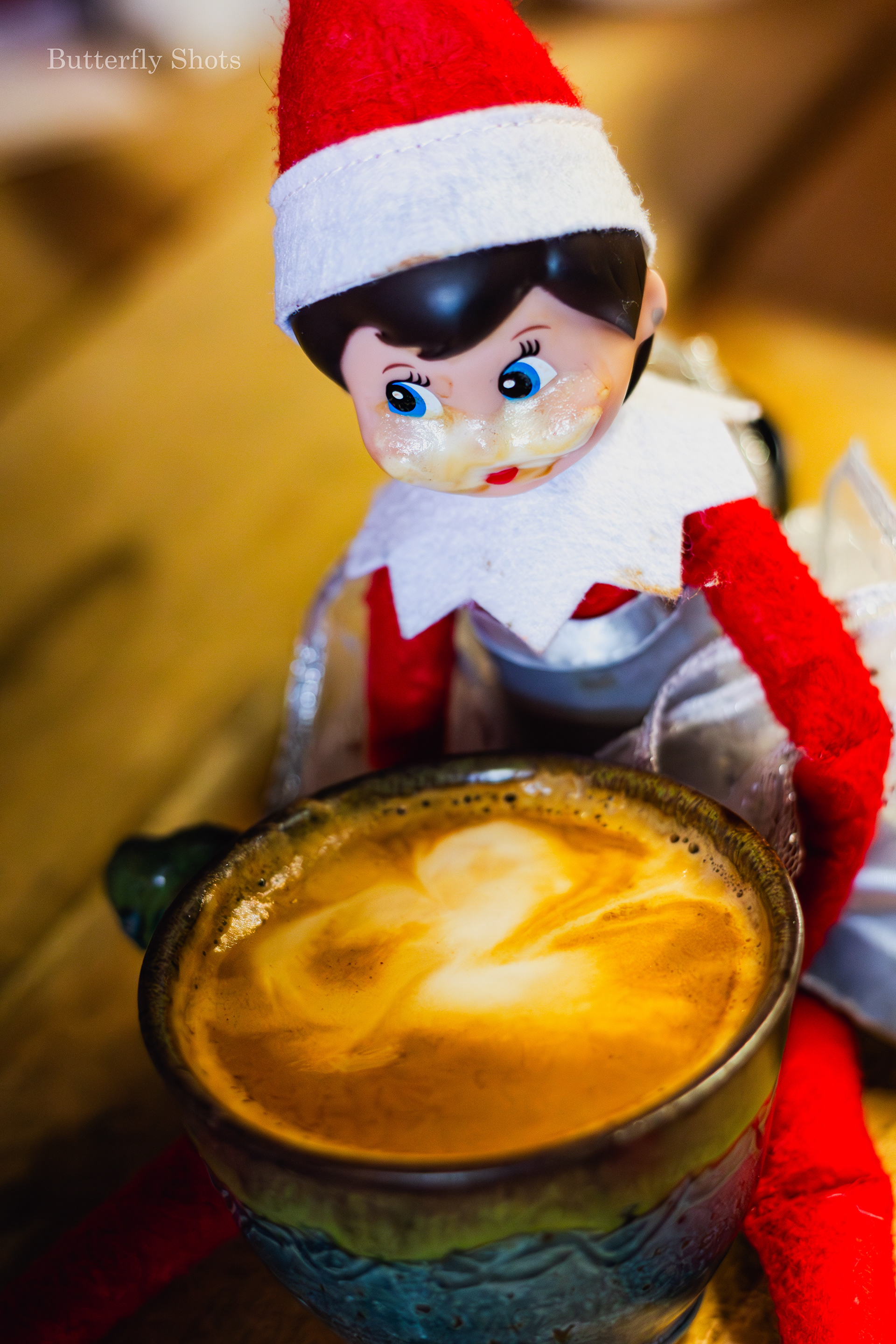Product photography of a cortado coffee with an elf
