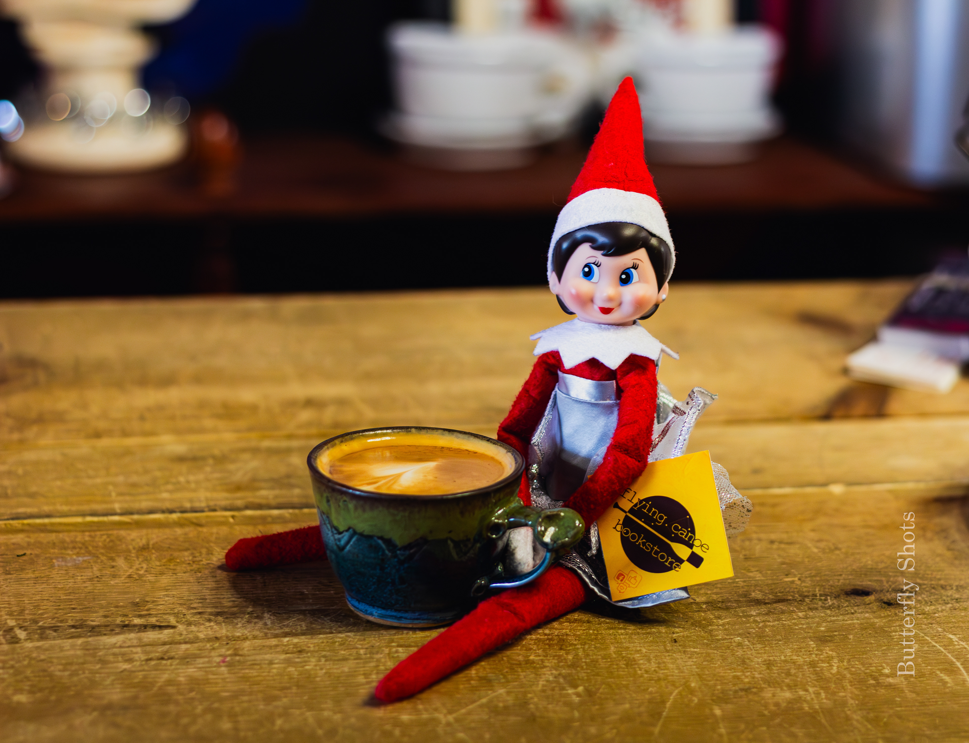 Product photography of a cortado coffee with an elf