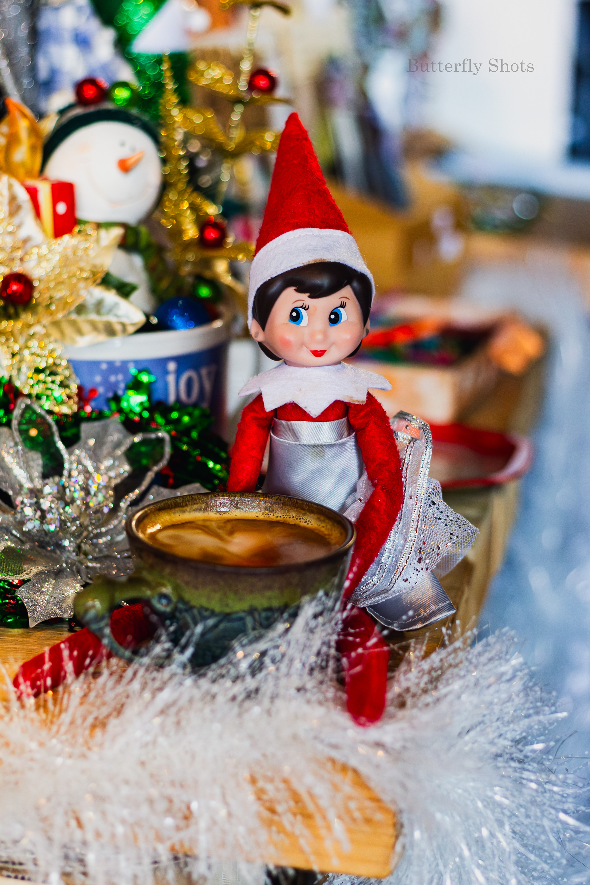 Product photography of a cortado coffee with an elf