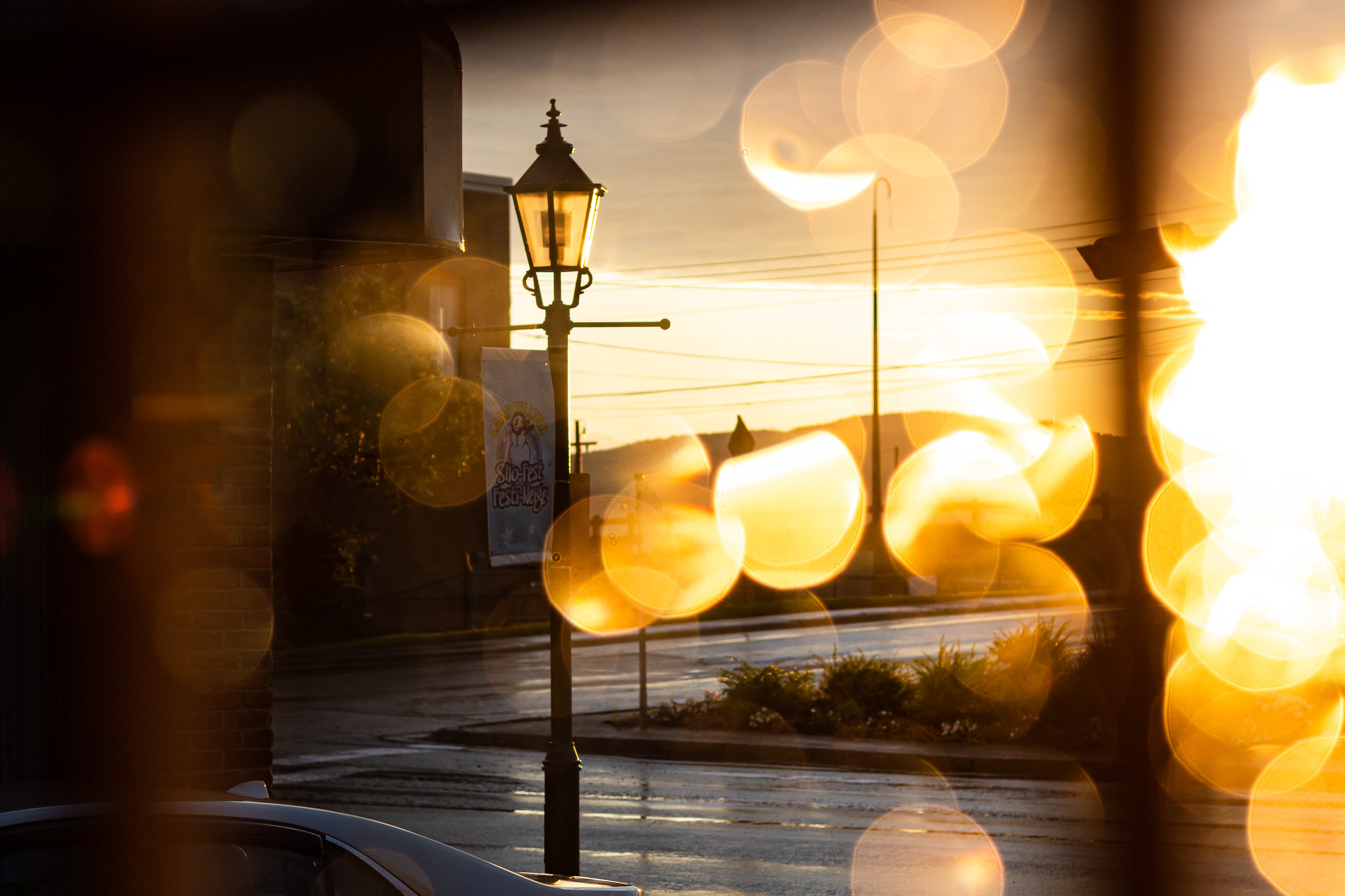 Street photography lamp post at sunset after rain