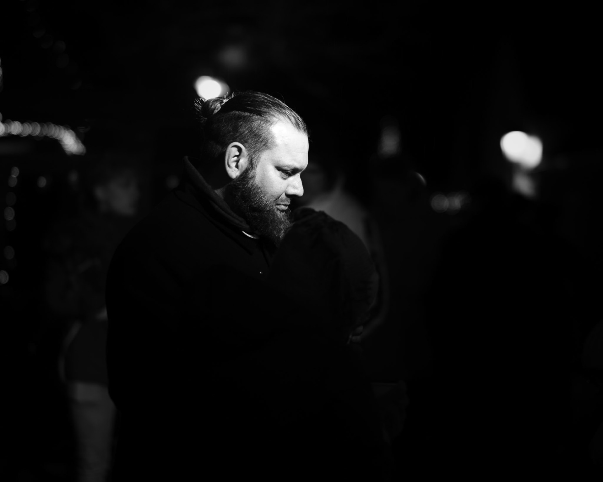 Nachtelijke meditatie: baard en man bun in lichtcirkels.